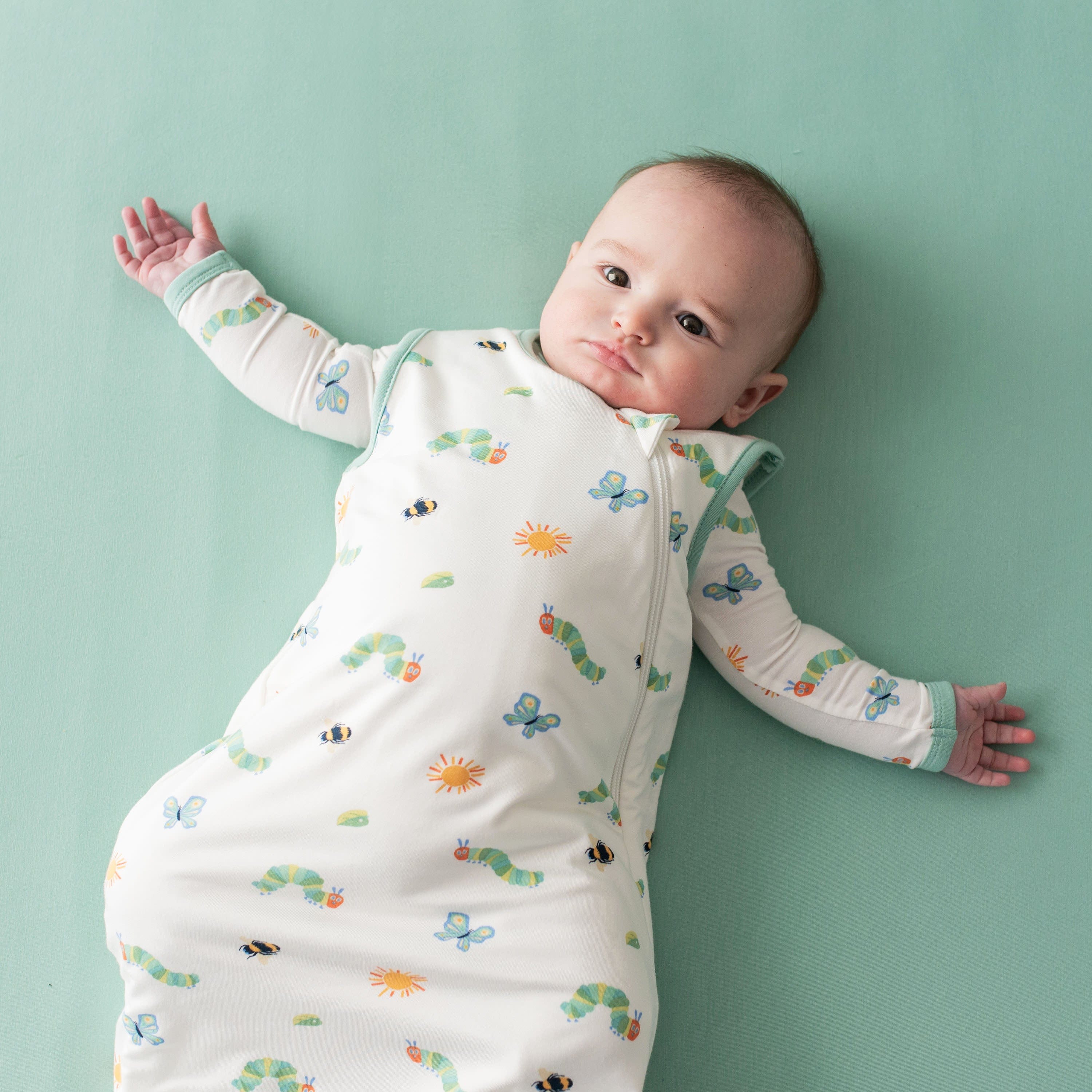 Infant wearing Kyte Baby 0.5 Sleep Bag in The Very Hungry Caterpillar™ and Friends