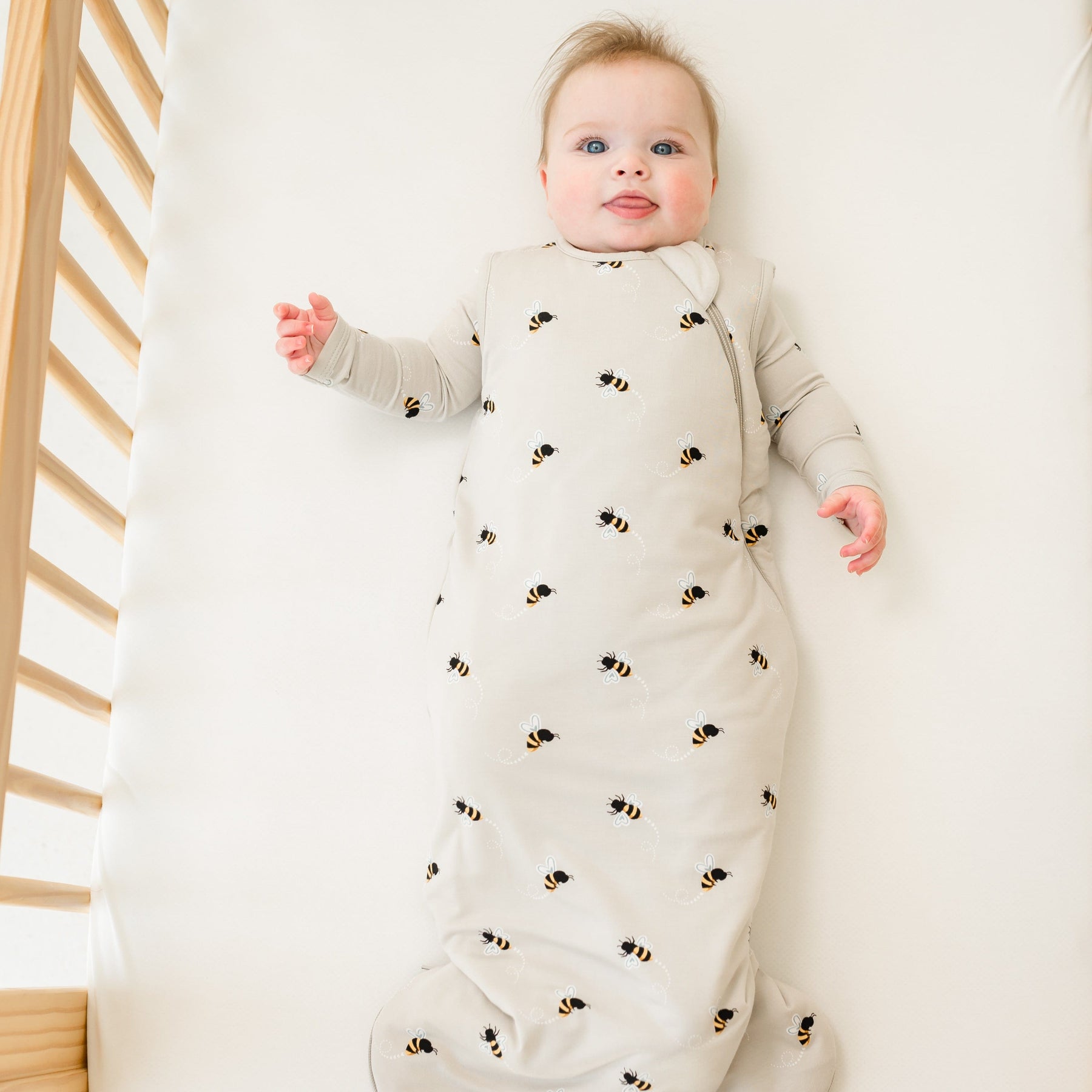 Baby in crib modeling Kyte Baby Sleep Bag in Bee Mine 1.0