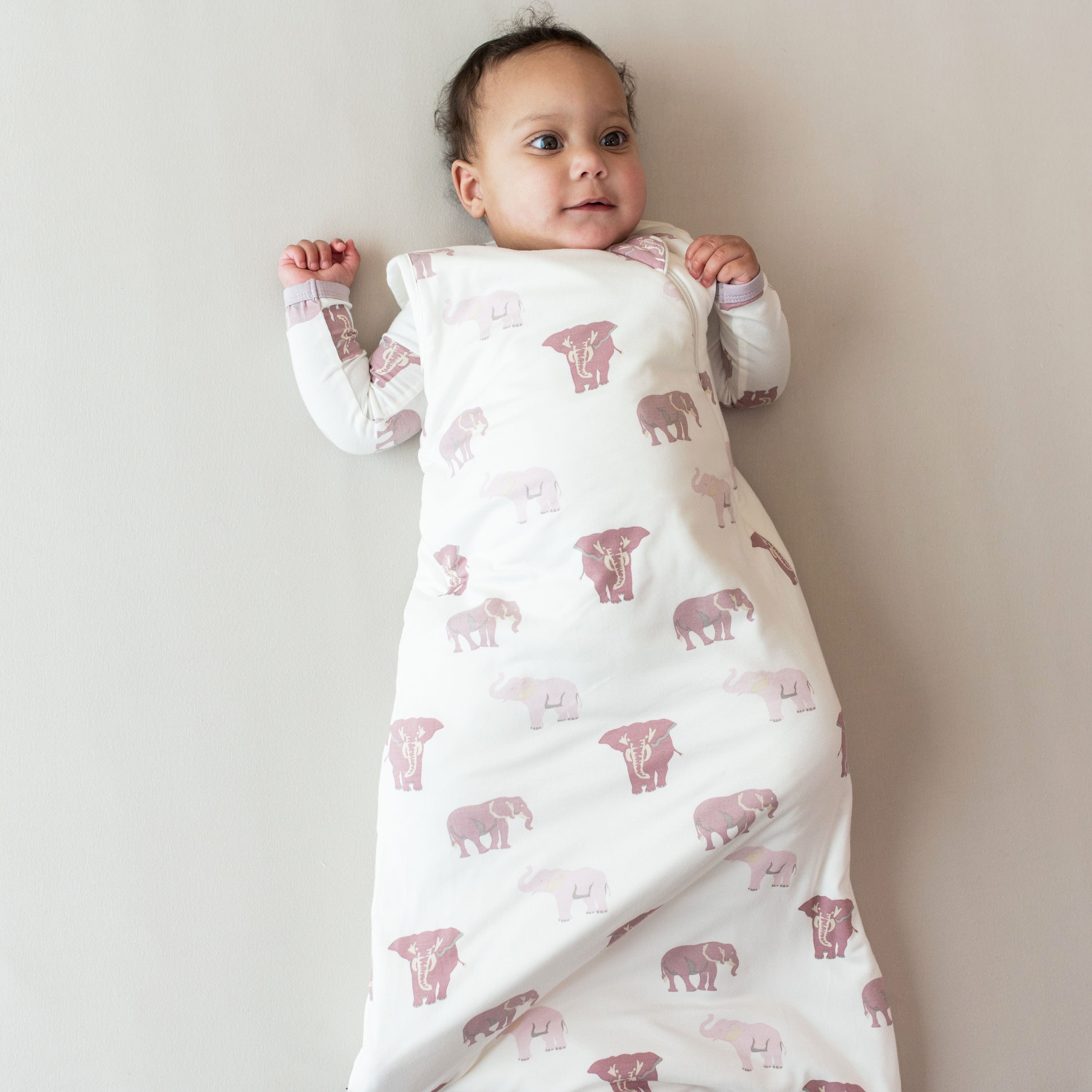 Infant wearing Kyte Baby Sleep Bag in Elephant 1.0