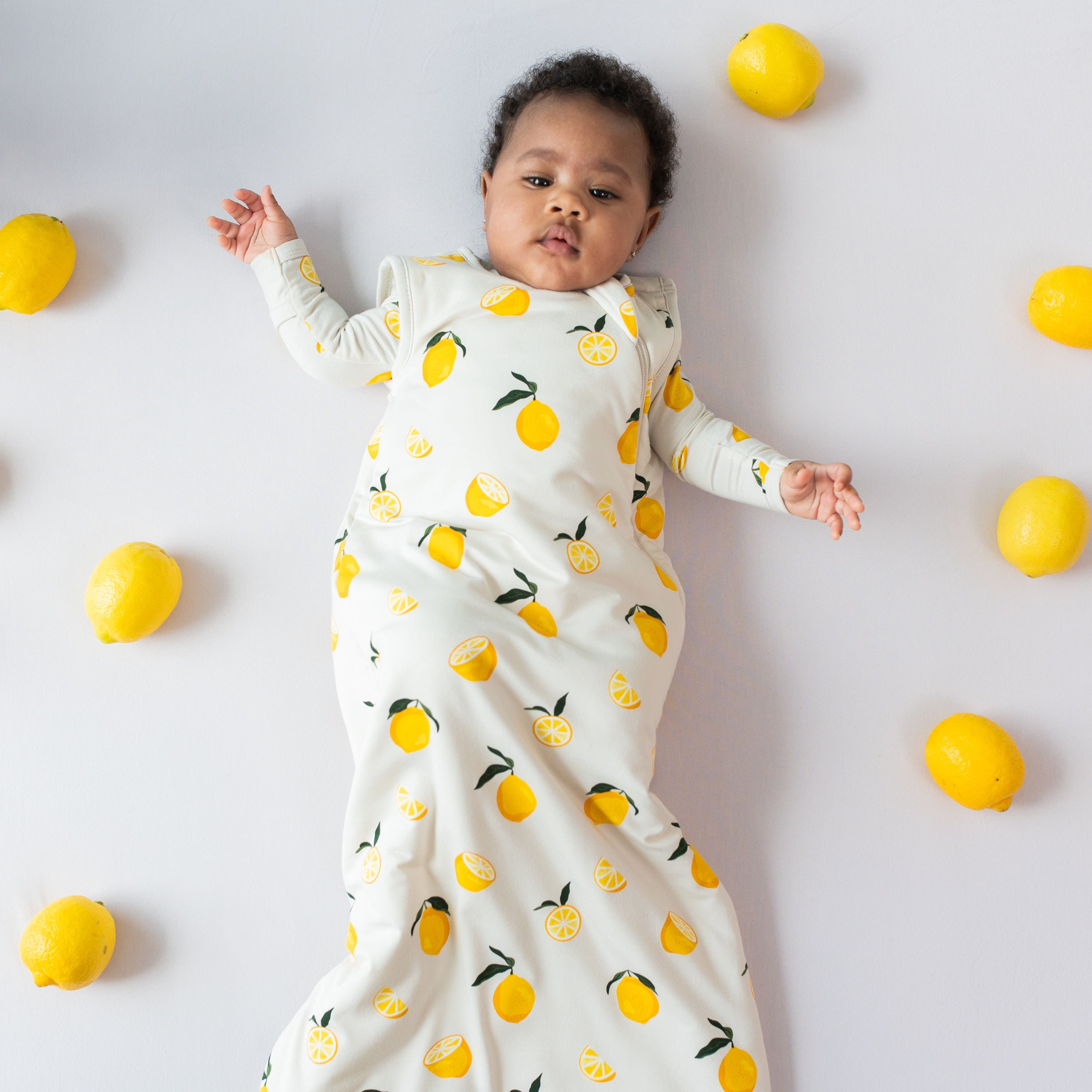 Infant wearing Kyte Baby Sleep Bag in Lemon 1.0