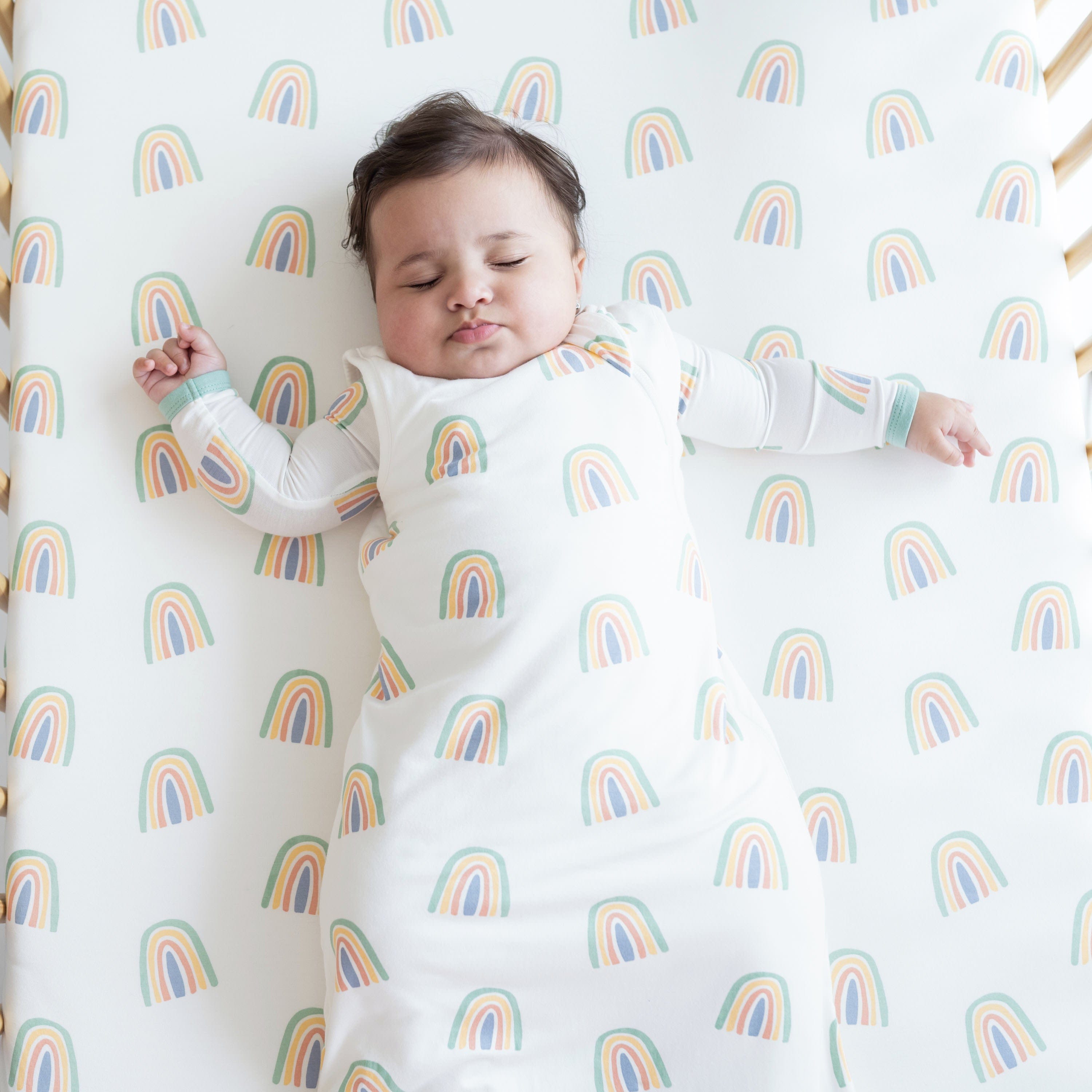 Infant sleeping in Kyte Baby Sleep Bag in Wasabi Rainbow 1.0