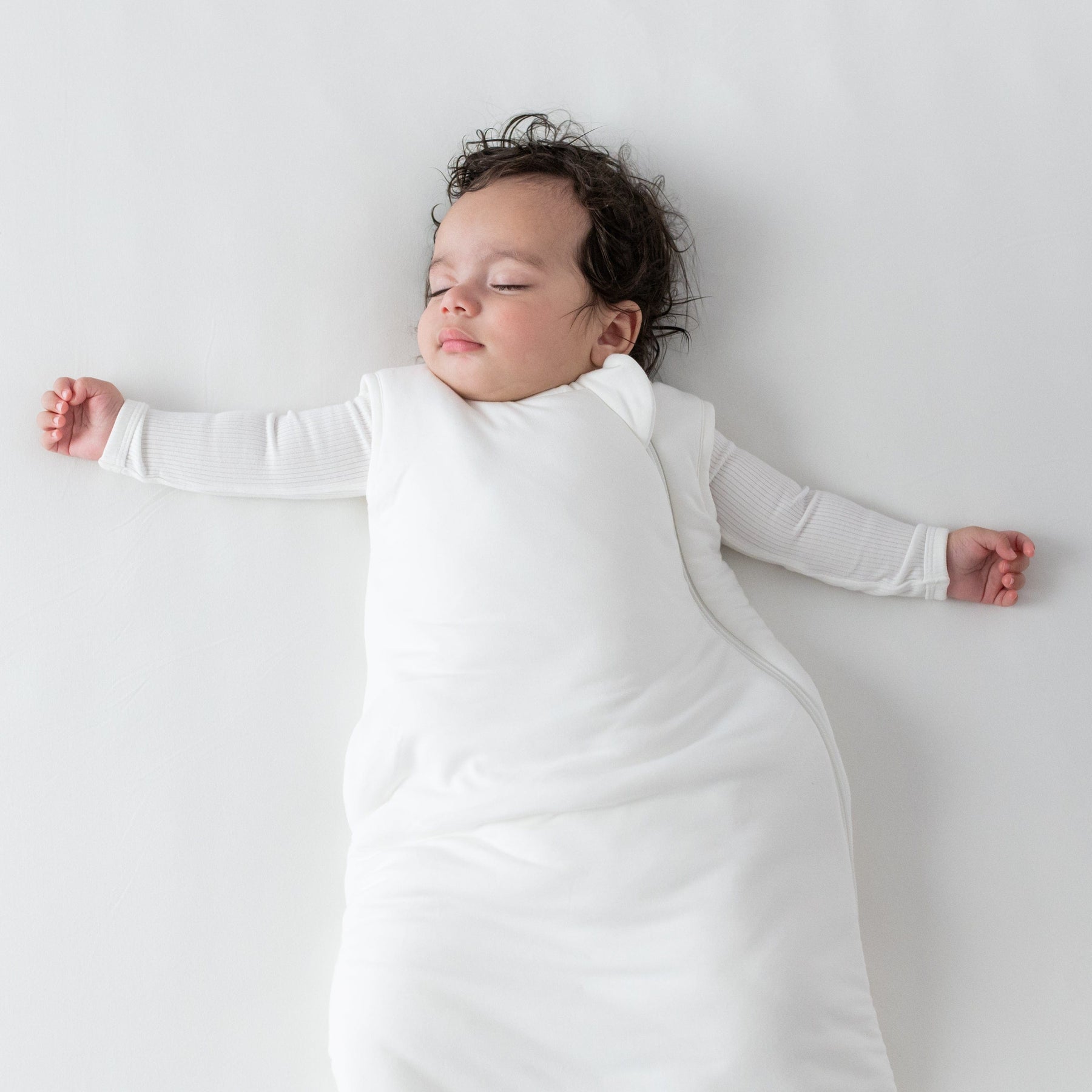Baby wearing Kyte Baby bamboo Sleep Bag in Cloud 2.5