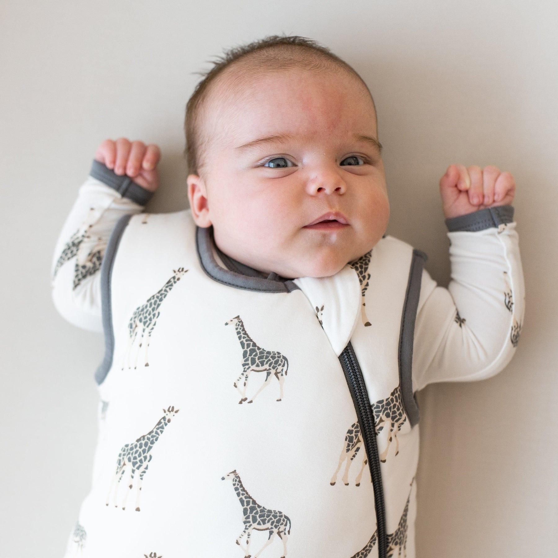 Baby wearing Kyte Baby bamboo Sleep Bag in Giraffe TOG 2.5