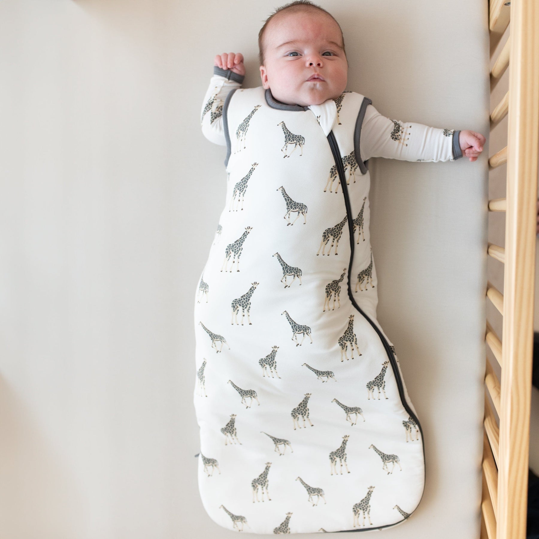 Infant wearing Kyte Baby Sleep Bag in Giraffe 2.5