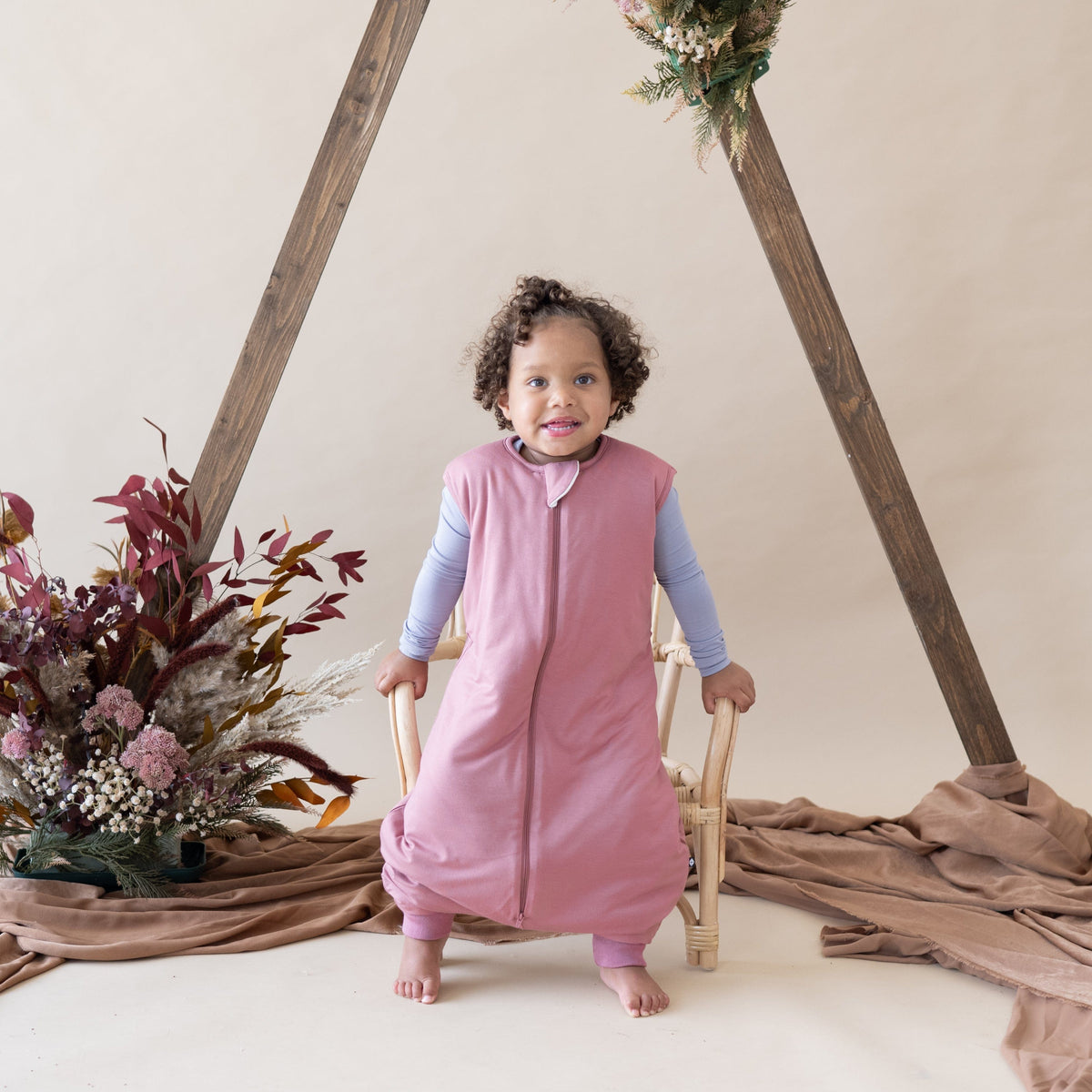 Toddler wearing Kyte Baby Sleep Bag Walker in Dusty Rose 1.0