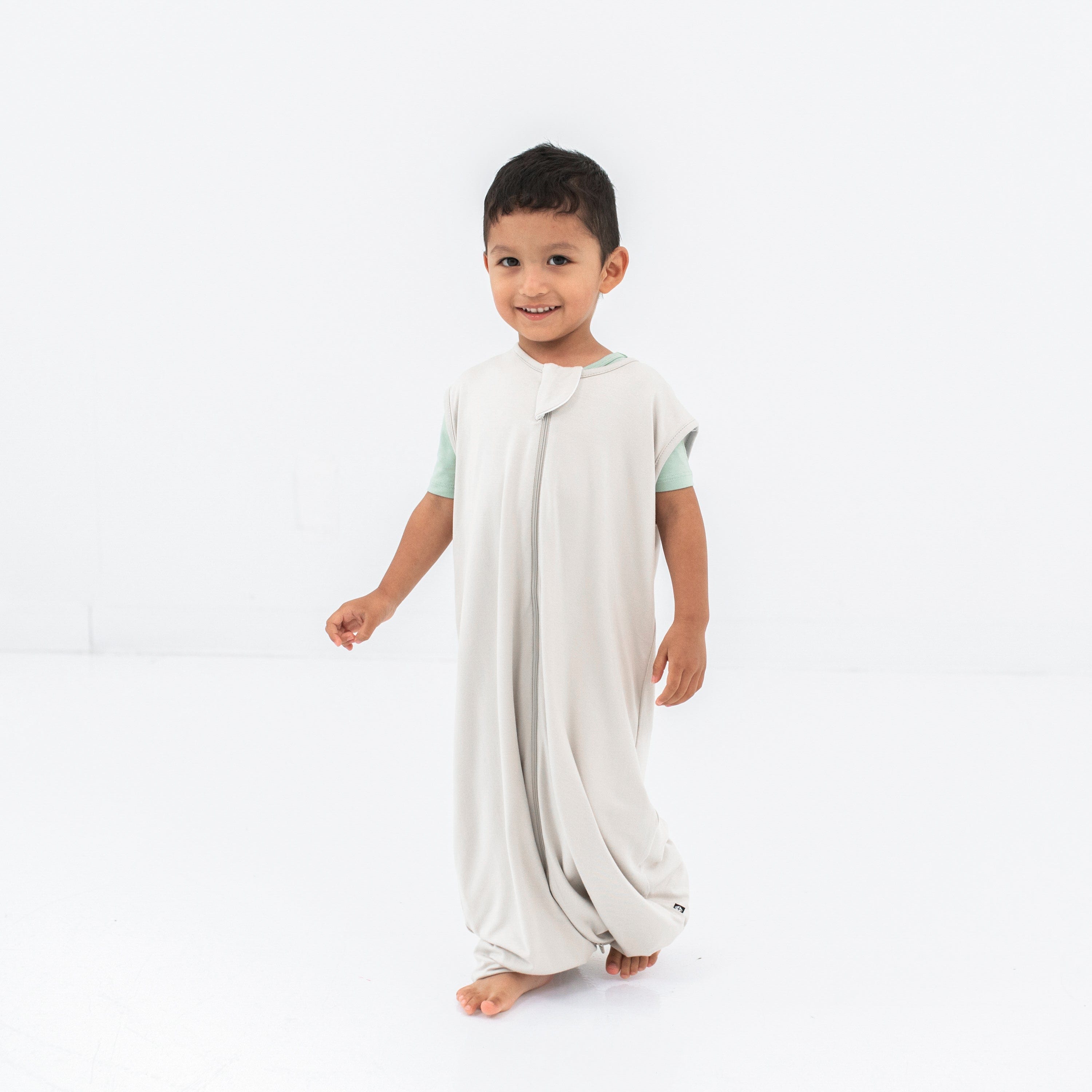 Child model wearing the Sleep Bag Walker in Oat 0.5