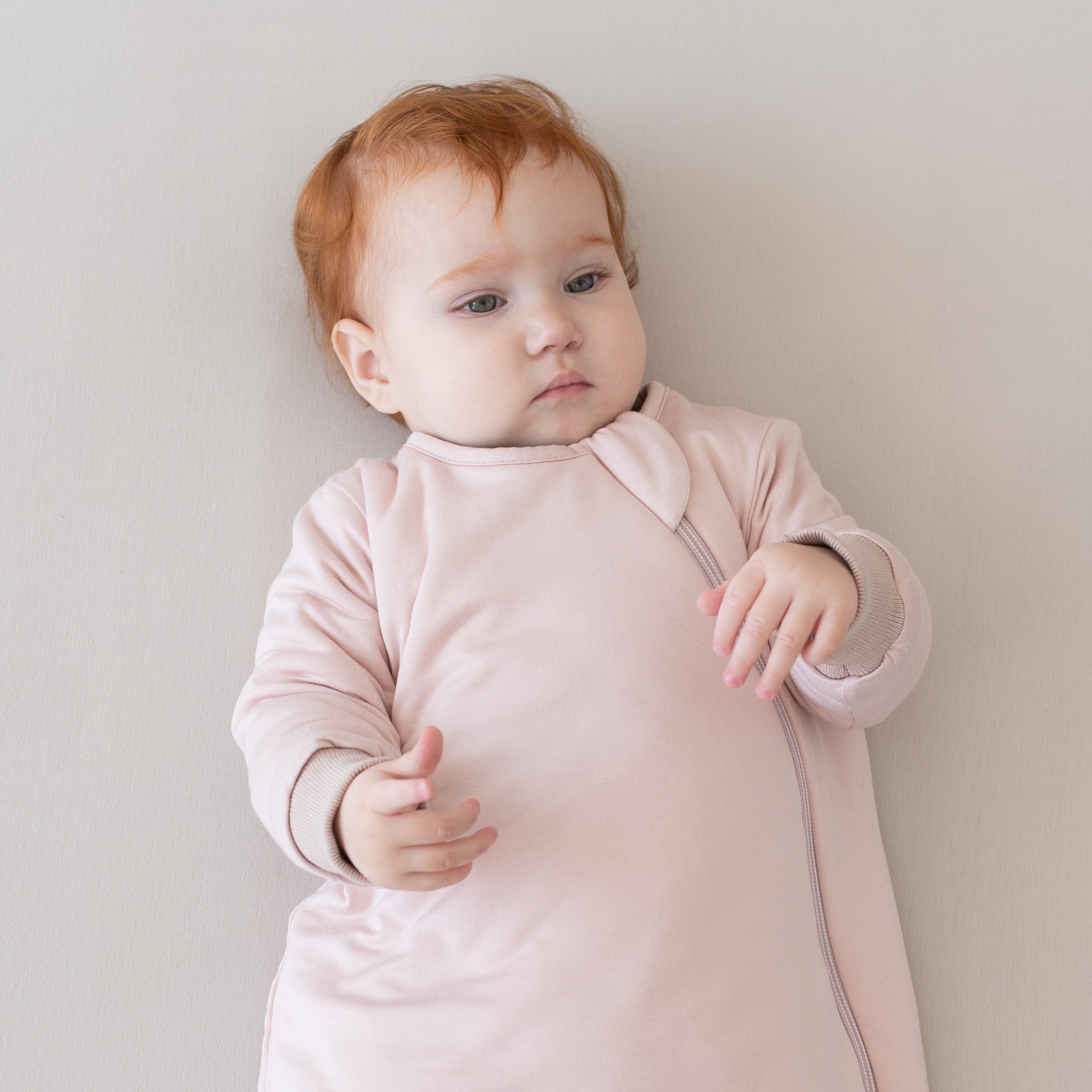 Baby in wearable blanket Kyte Baby Slumber Bag in Blush pink