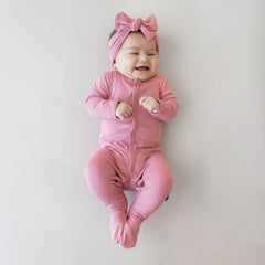Baby wearing Snap Footie in Apple Blossom