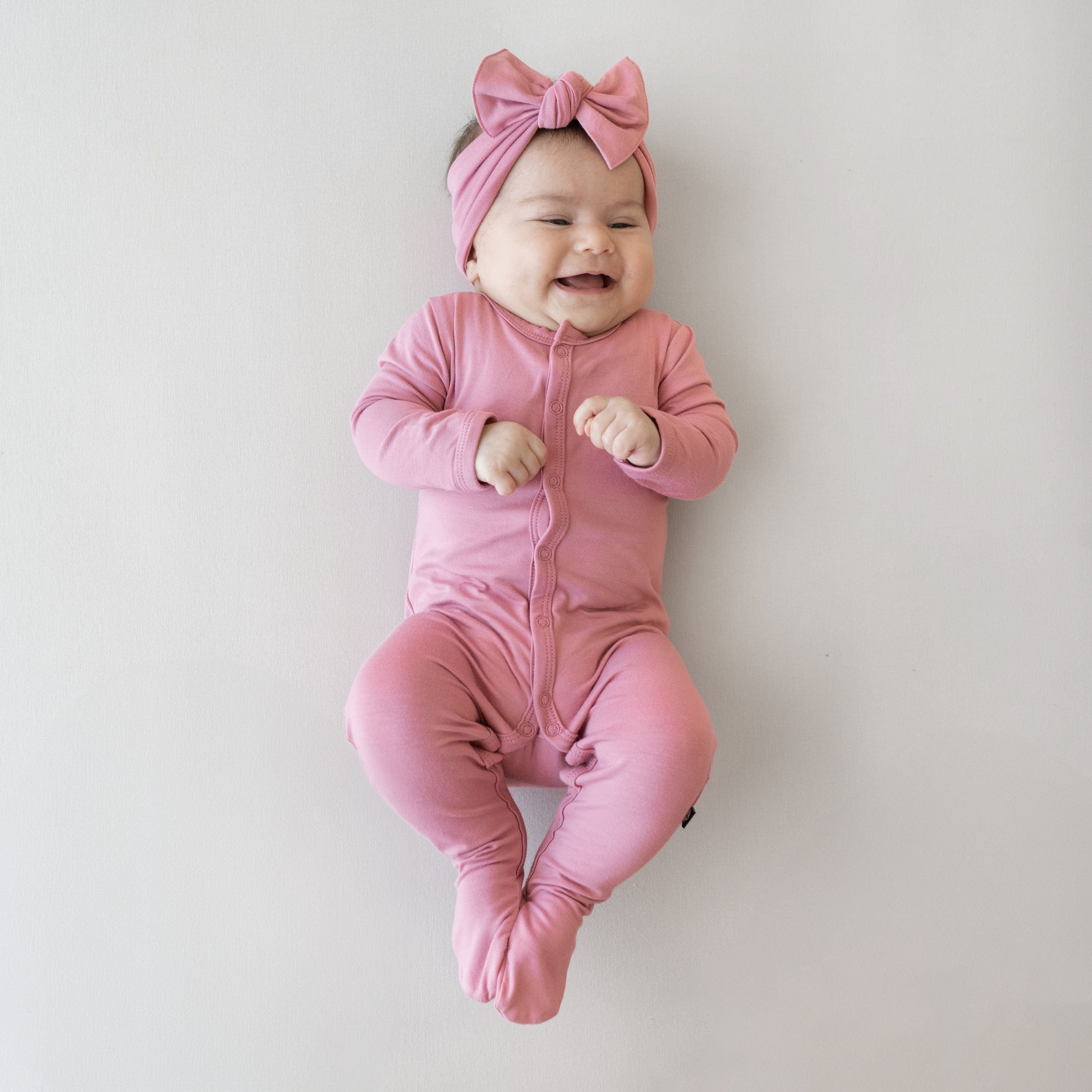 Baby wearing Snap Footie in Apple Blossom