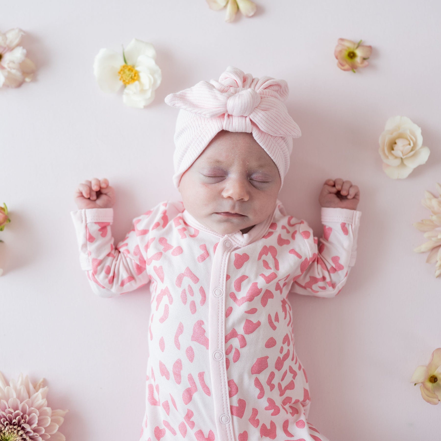 Infant wearing Kyte Baby Romper in Sakura Leopard