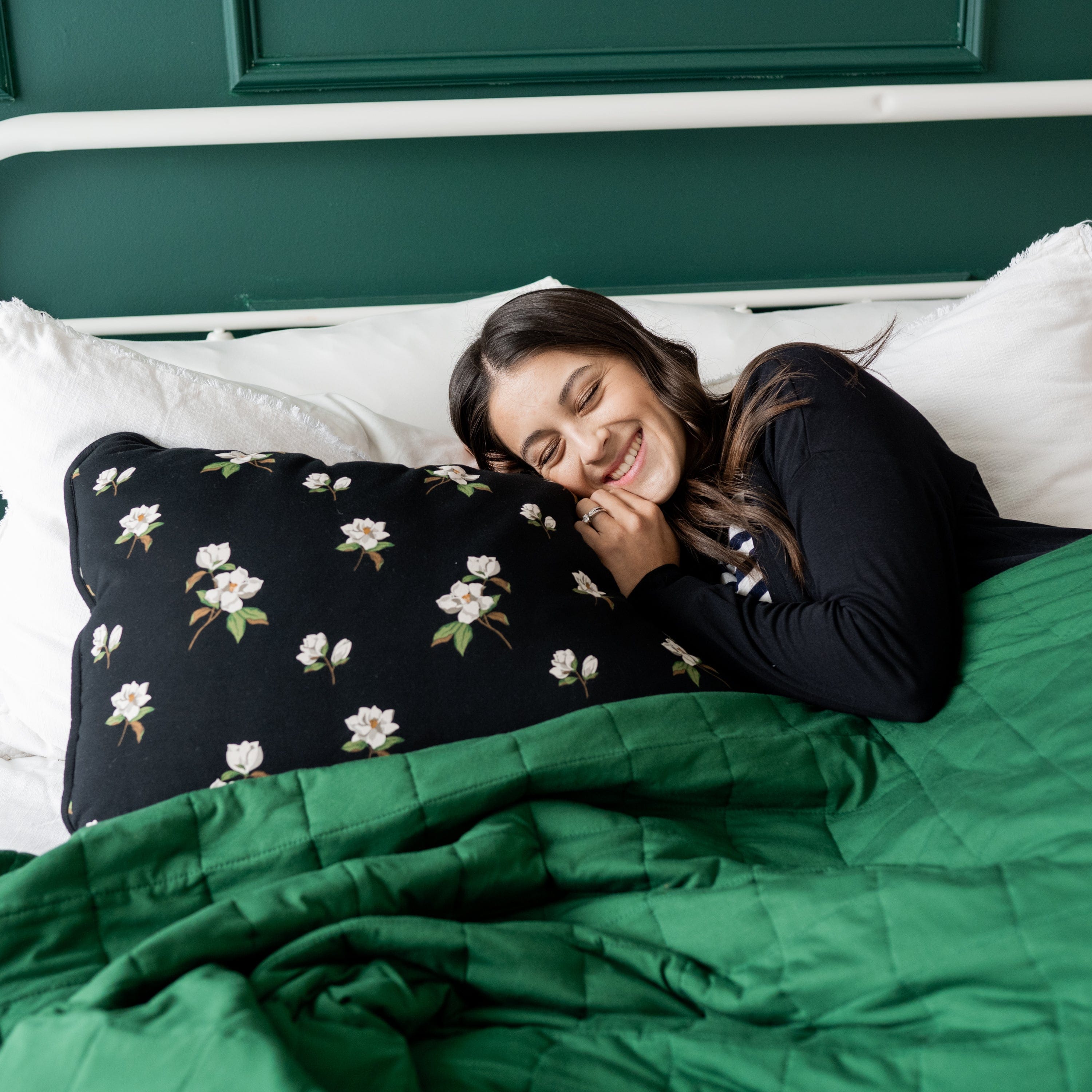 Woman Laying on Kyte Baby Standard Pillowcase in Big Midnight Magnolia