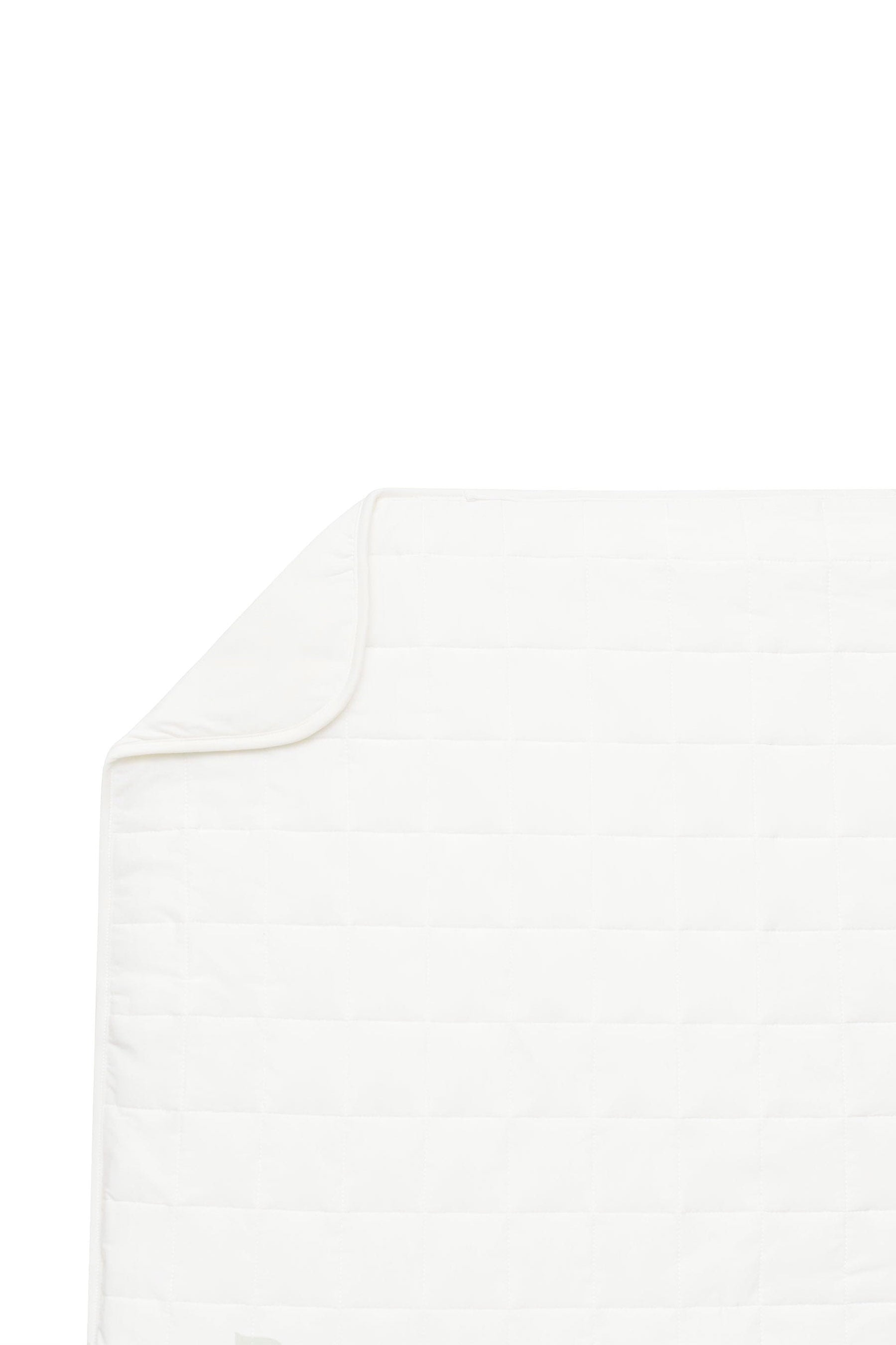 Flat lay of of Kyte Baby Quilted Toddler Blanket in Cloud 1.0 with corner folded inwards