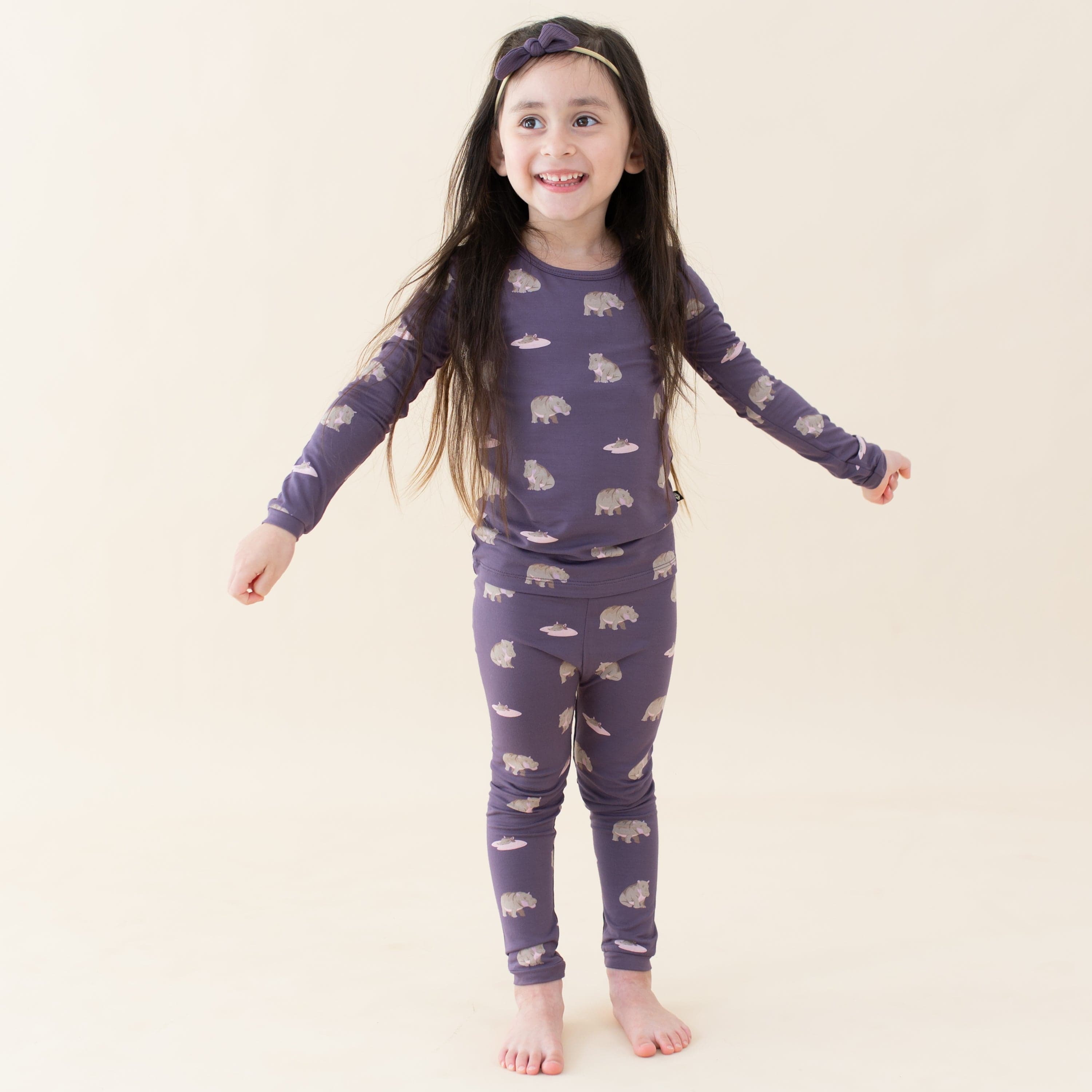 Toddler wearing Kyte Baby Long Sleeve Pajamas in Baby Hippo