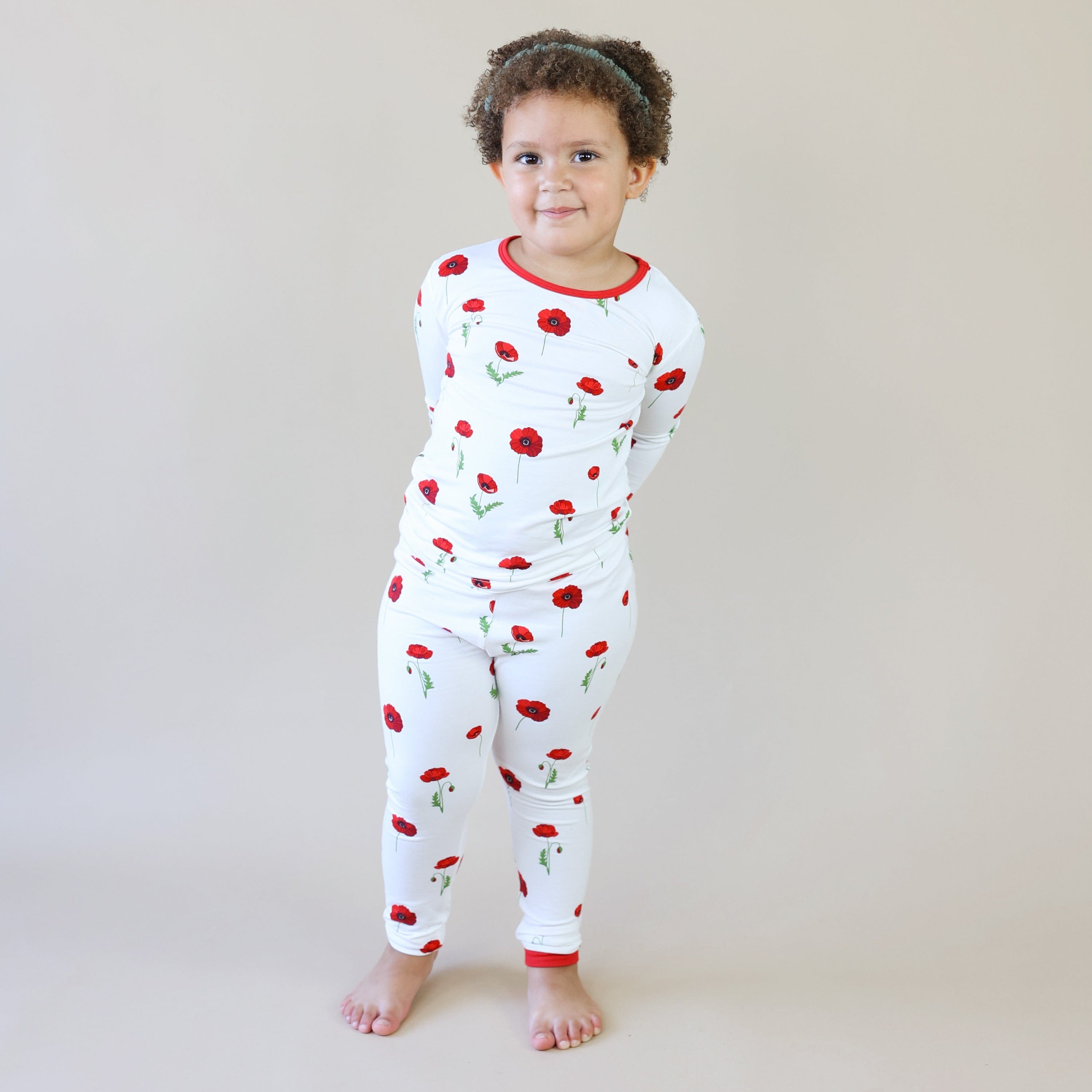 Child wearing Kyte Baby Long Sleeve Pajamas in Cloud Poppies