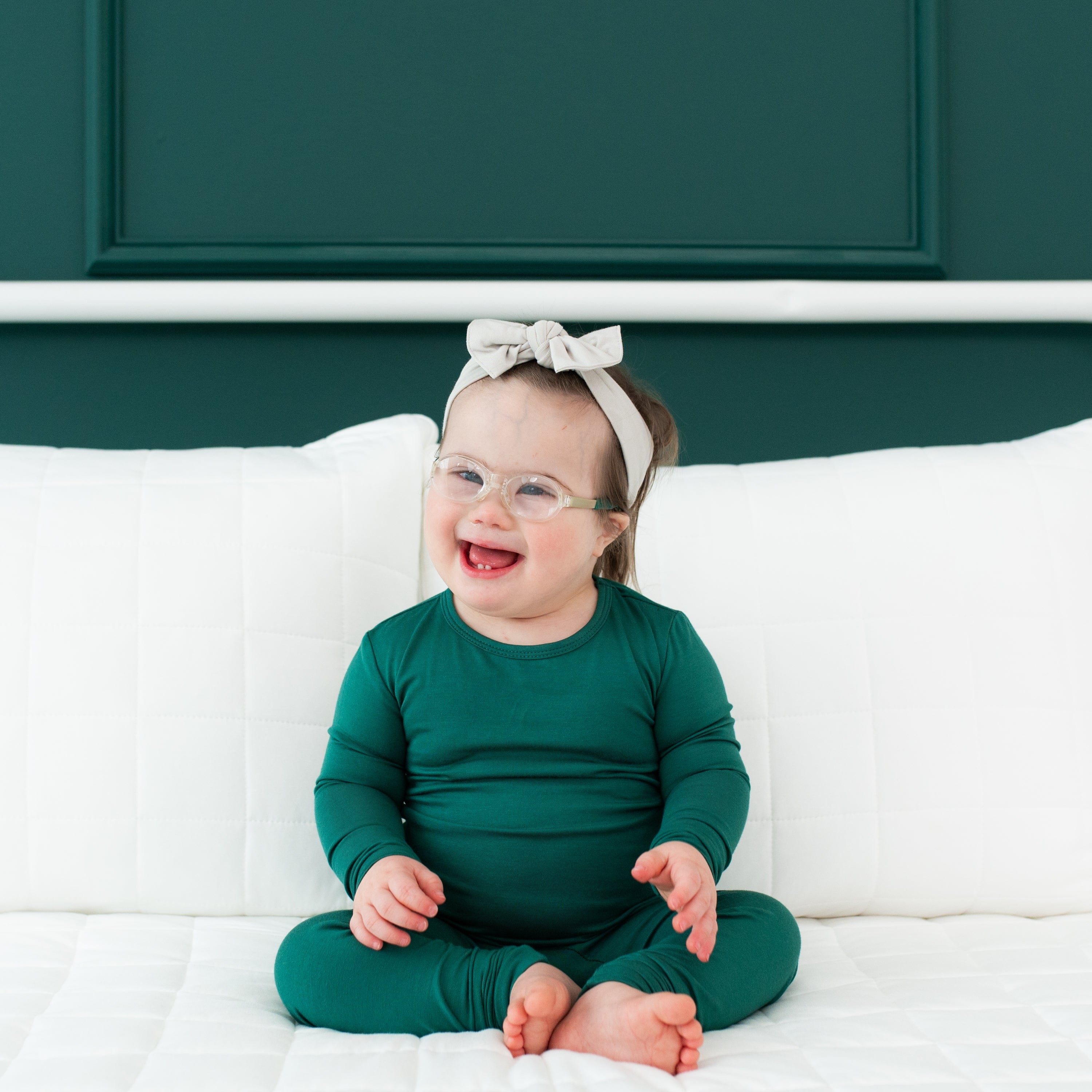Toddler wearing Long Sleeve Pajamas in Emerald and Headband Bow in Oat