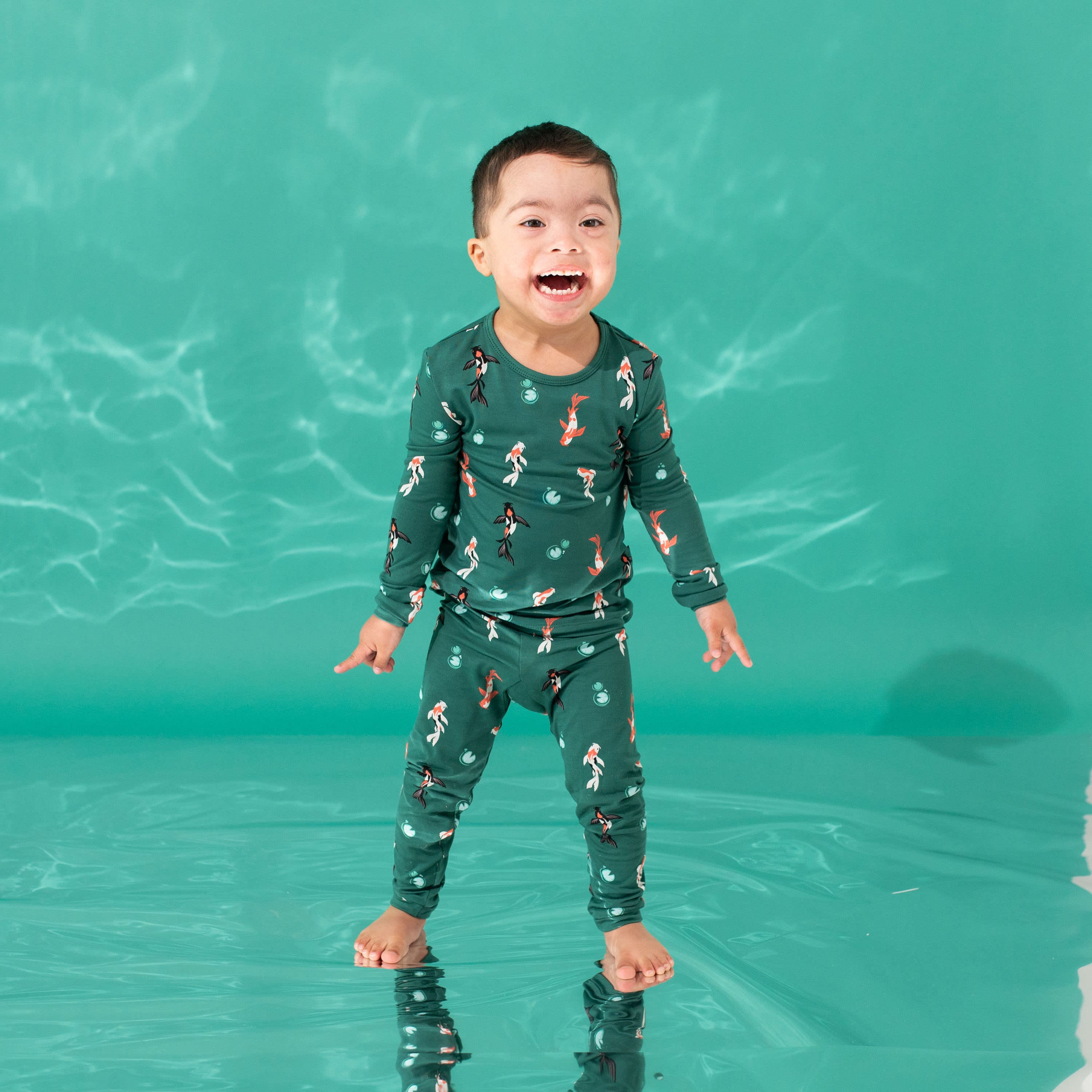 Child wearing Kyte Baby Long Sleeve Pajamas in Koi