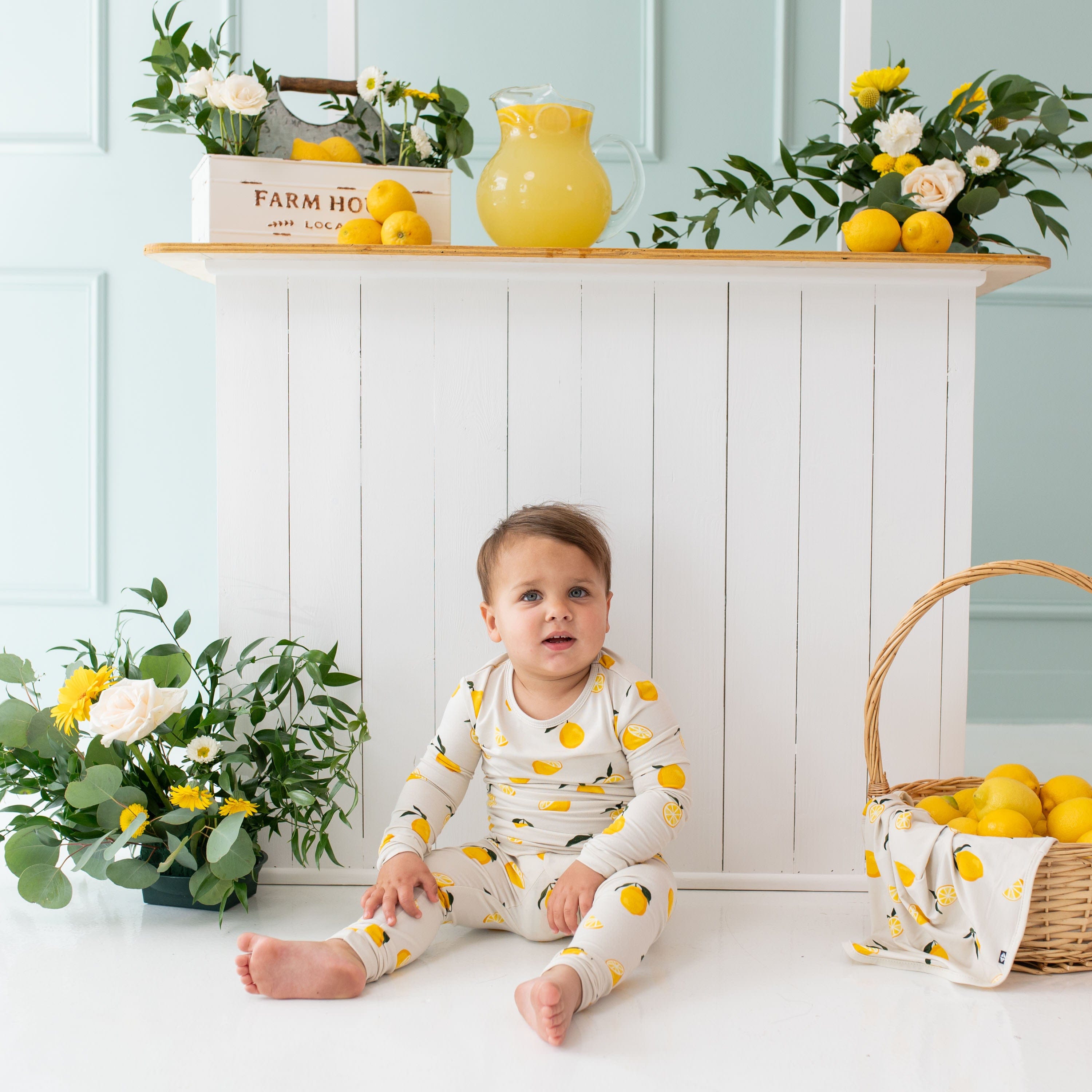 Child wearing Kyte Baby Long Sleeve Pajamas in Lemon