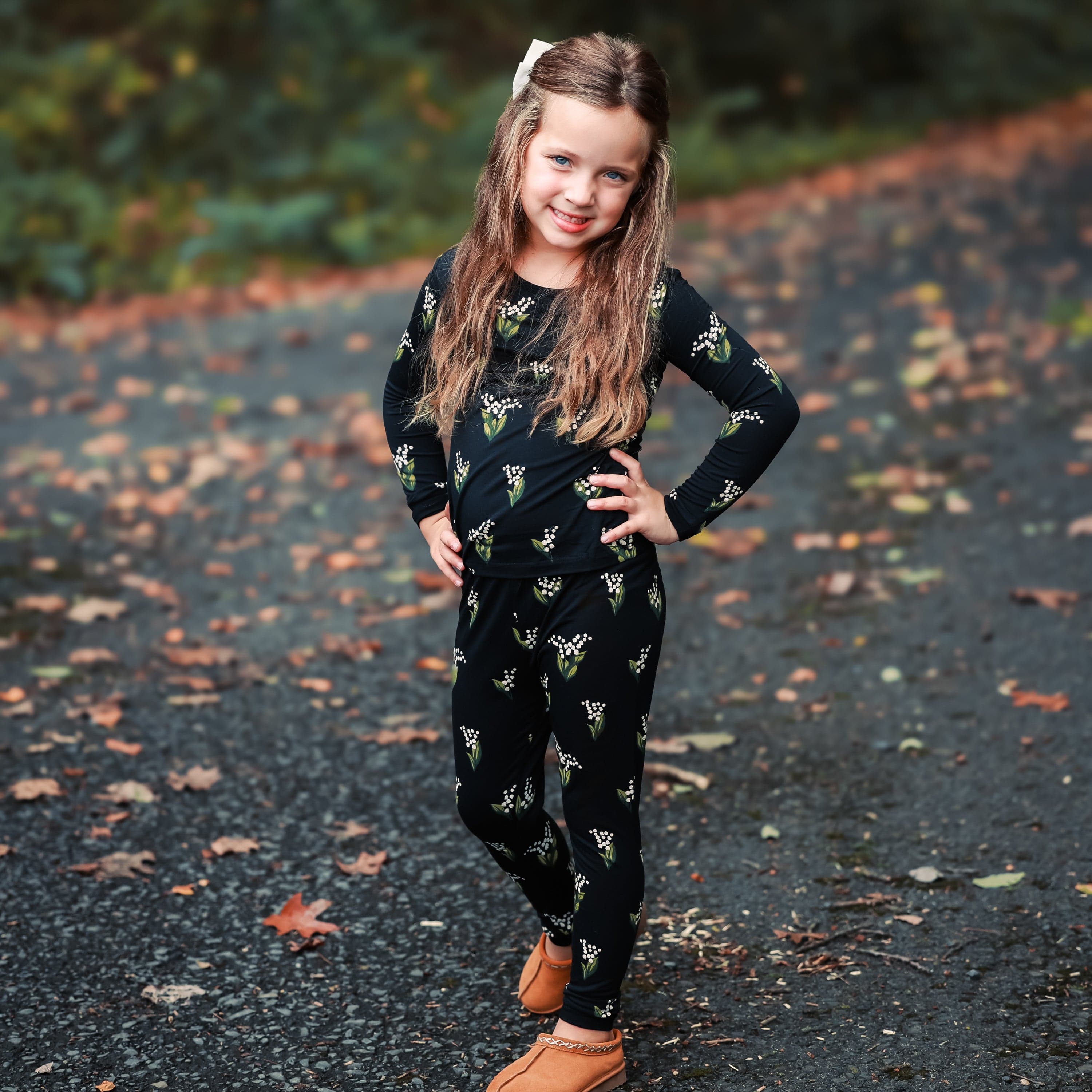 Child wearing Kyte Baby Long Sleeve Pajamas in Midnight Lily