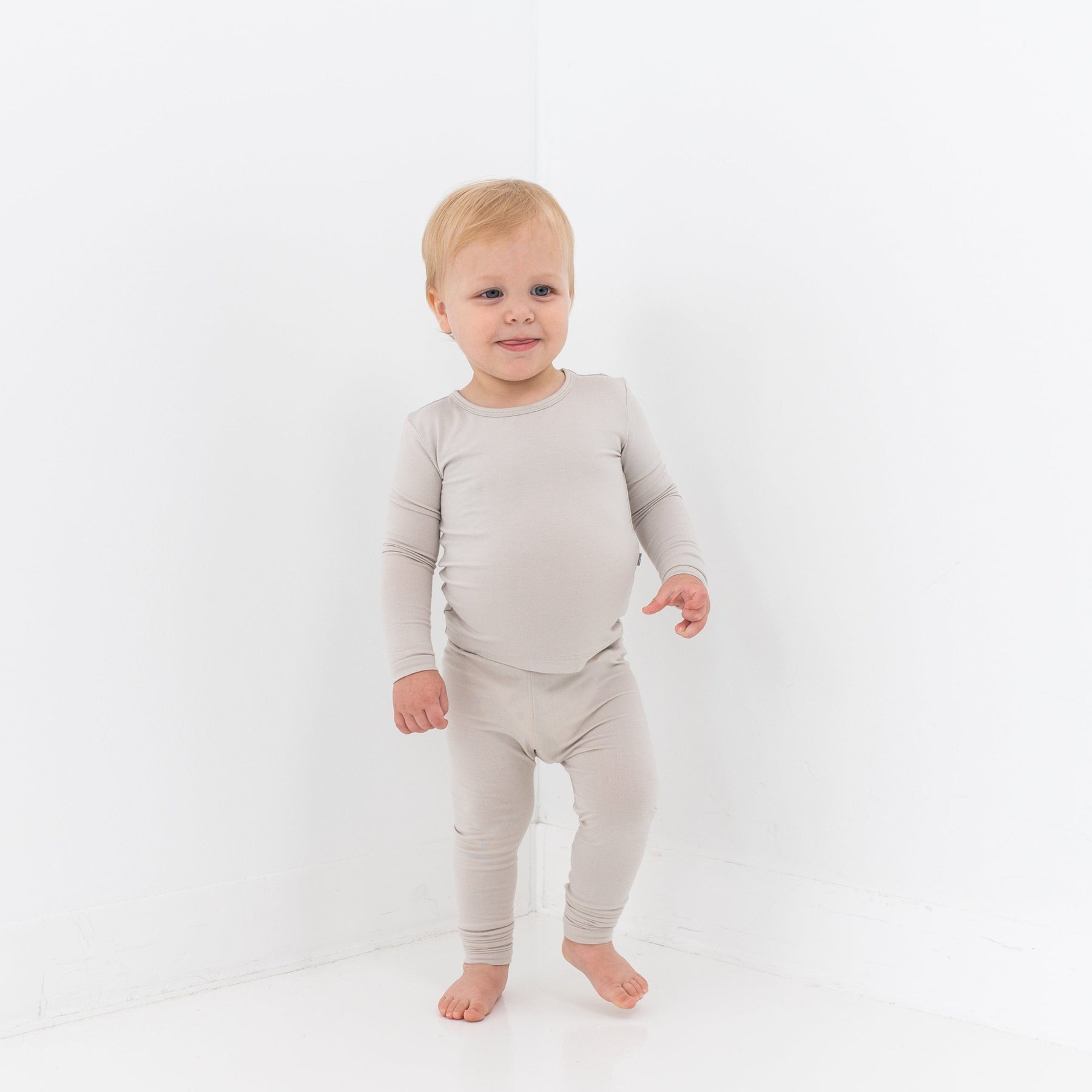 Toddler wearing Kyte Baby Long Sleeve Pajamas in Oat