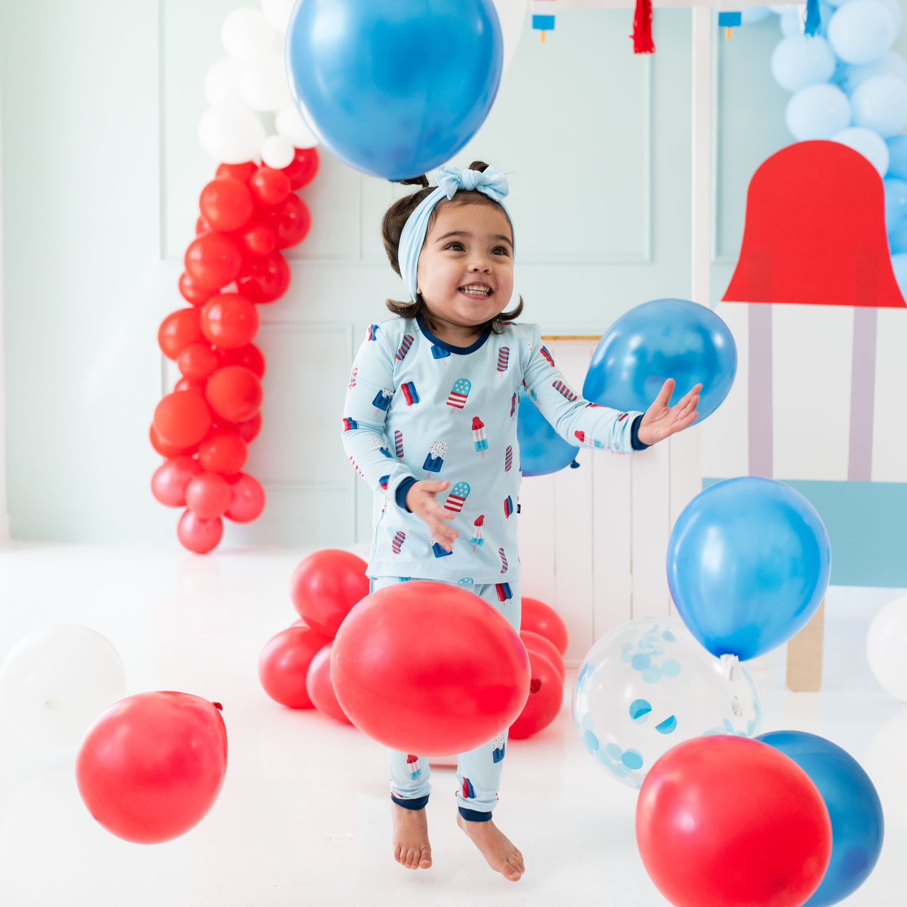 Toddler wearing Kyte Baby bamboo Long Sleeve Pajamas in Popsicle