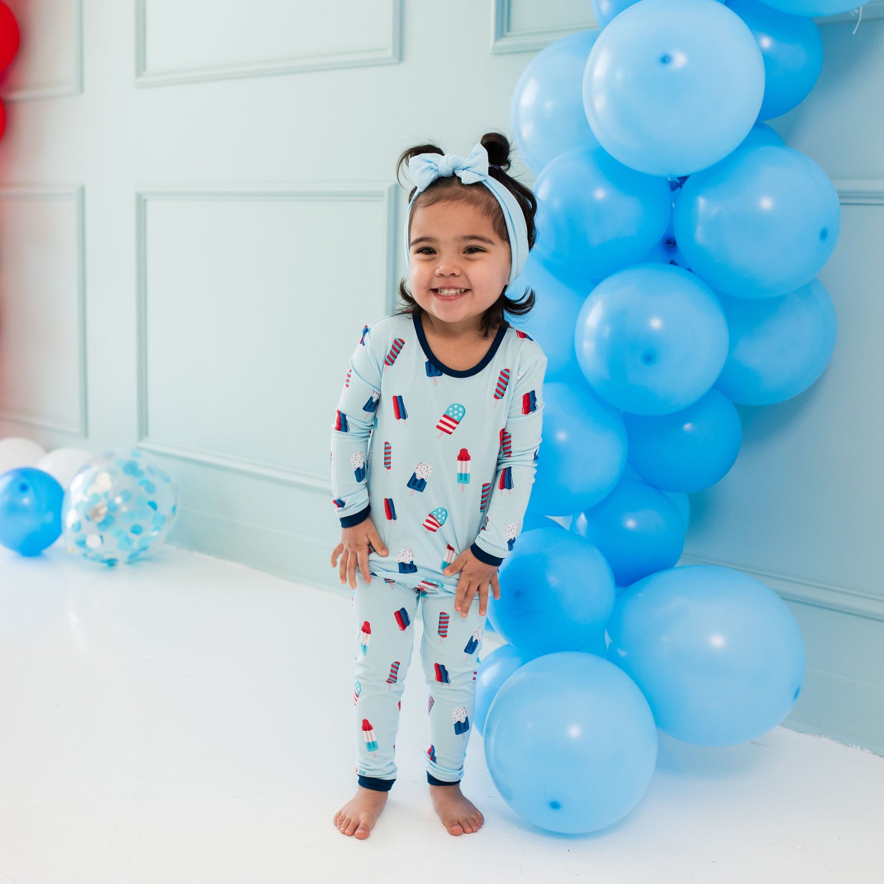 Child wearing Kyte Baby Long Sleeve Pajamas in Popsicle