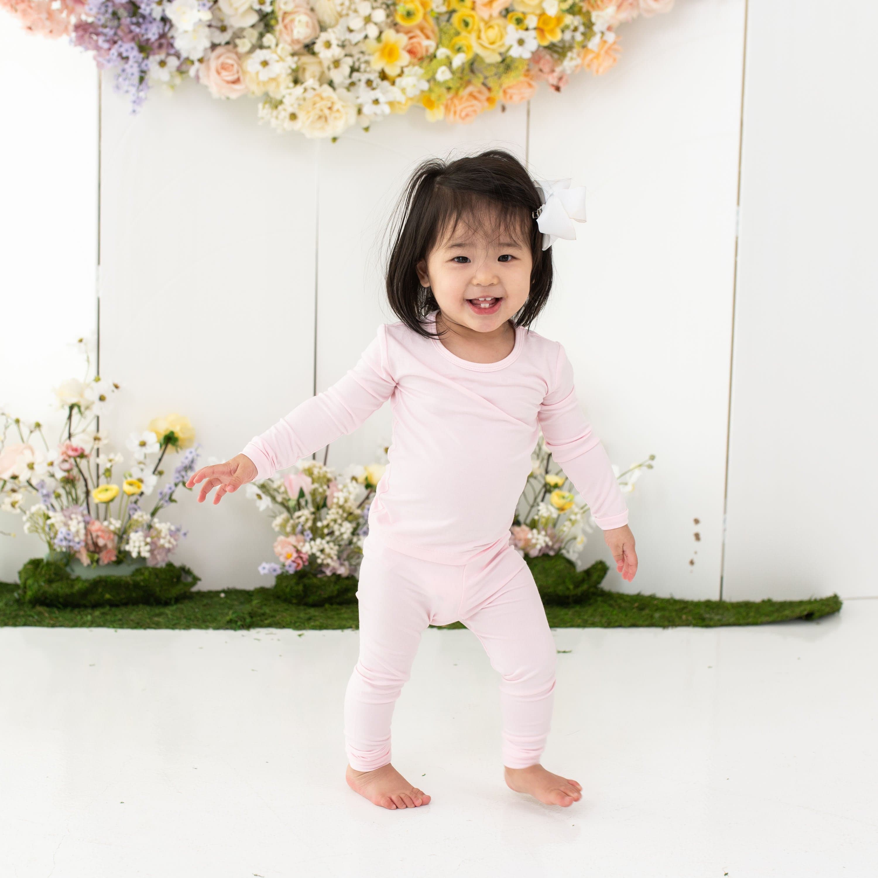 Child wearing Kyte Baby Long Sleeve Pajamas in Sakura