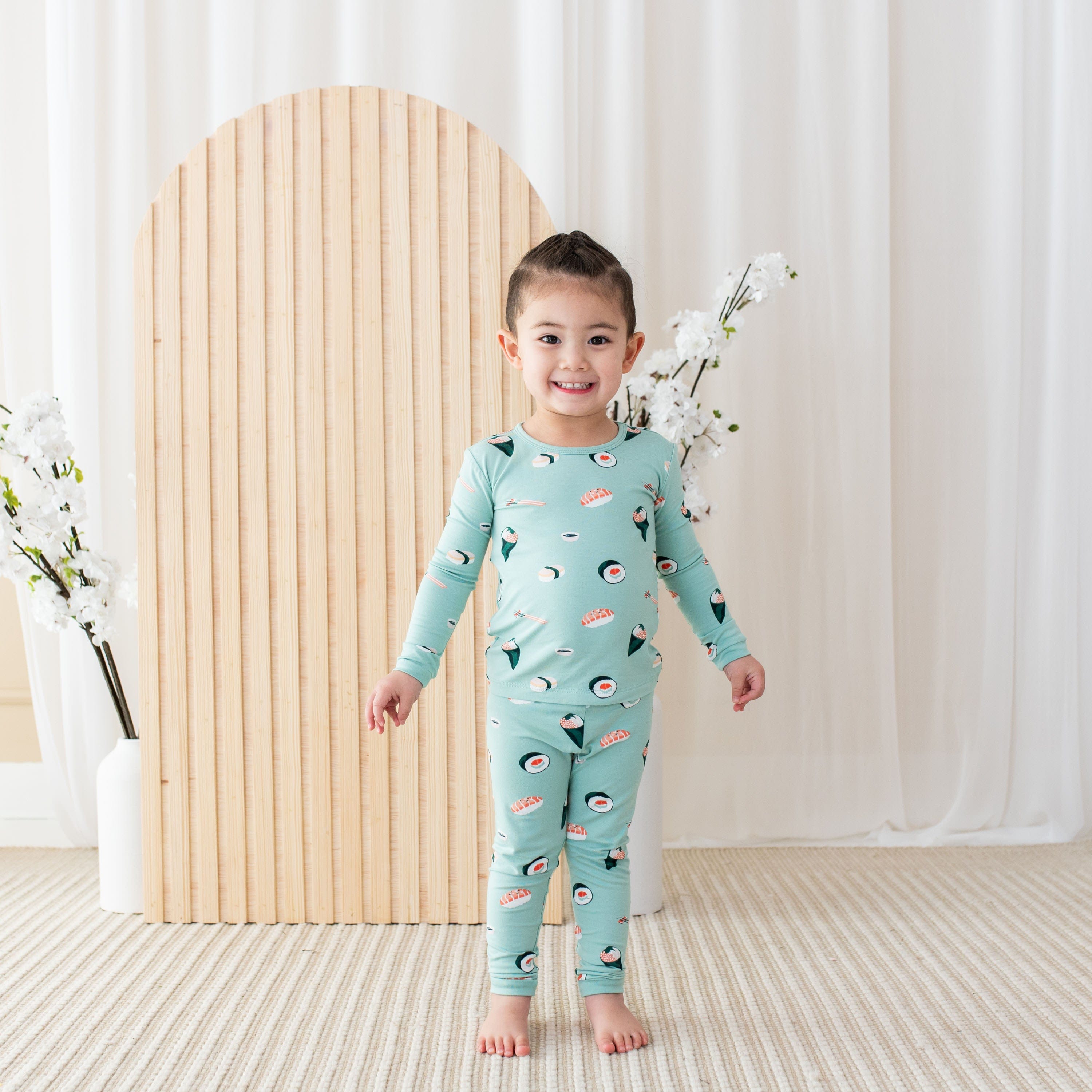 Child wearing Kyte Baby Long Sleeve Pajamas in Sushi