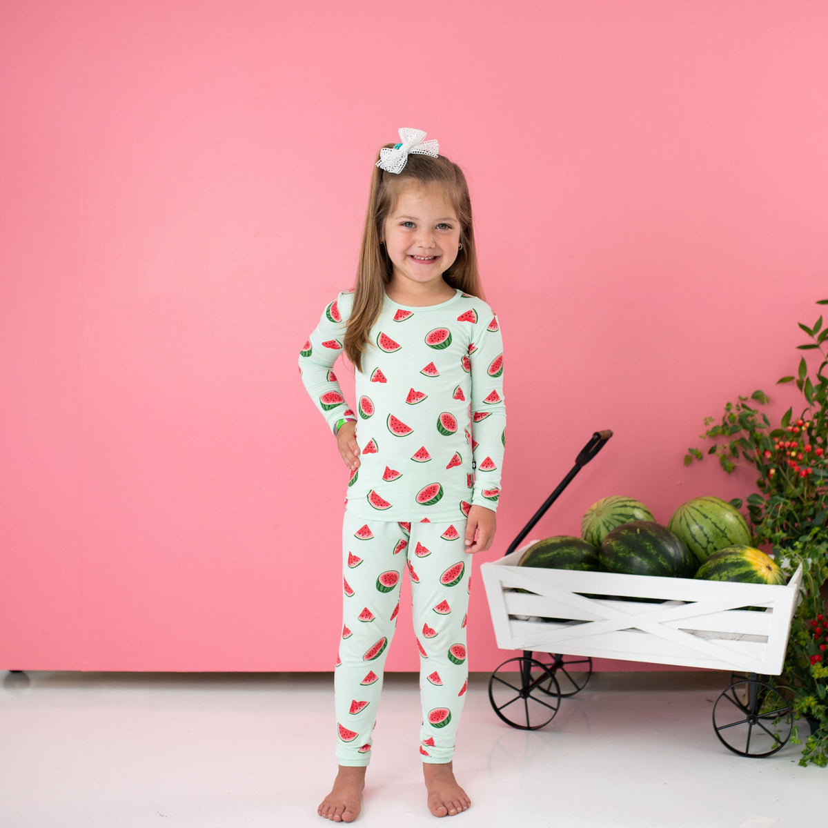 Child wearing Kyte Baby Long Sleeve Pajamas in Watermelon