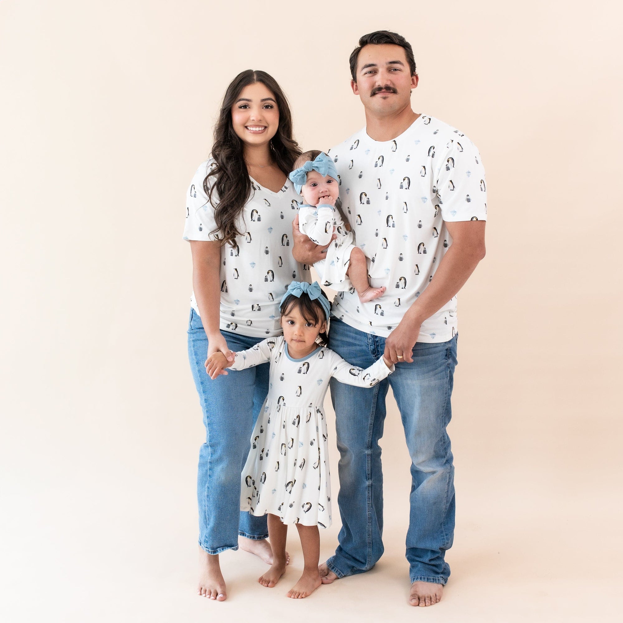 Family wearing matching outfits in Penguin print