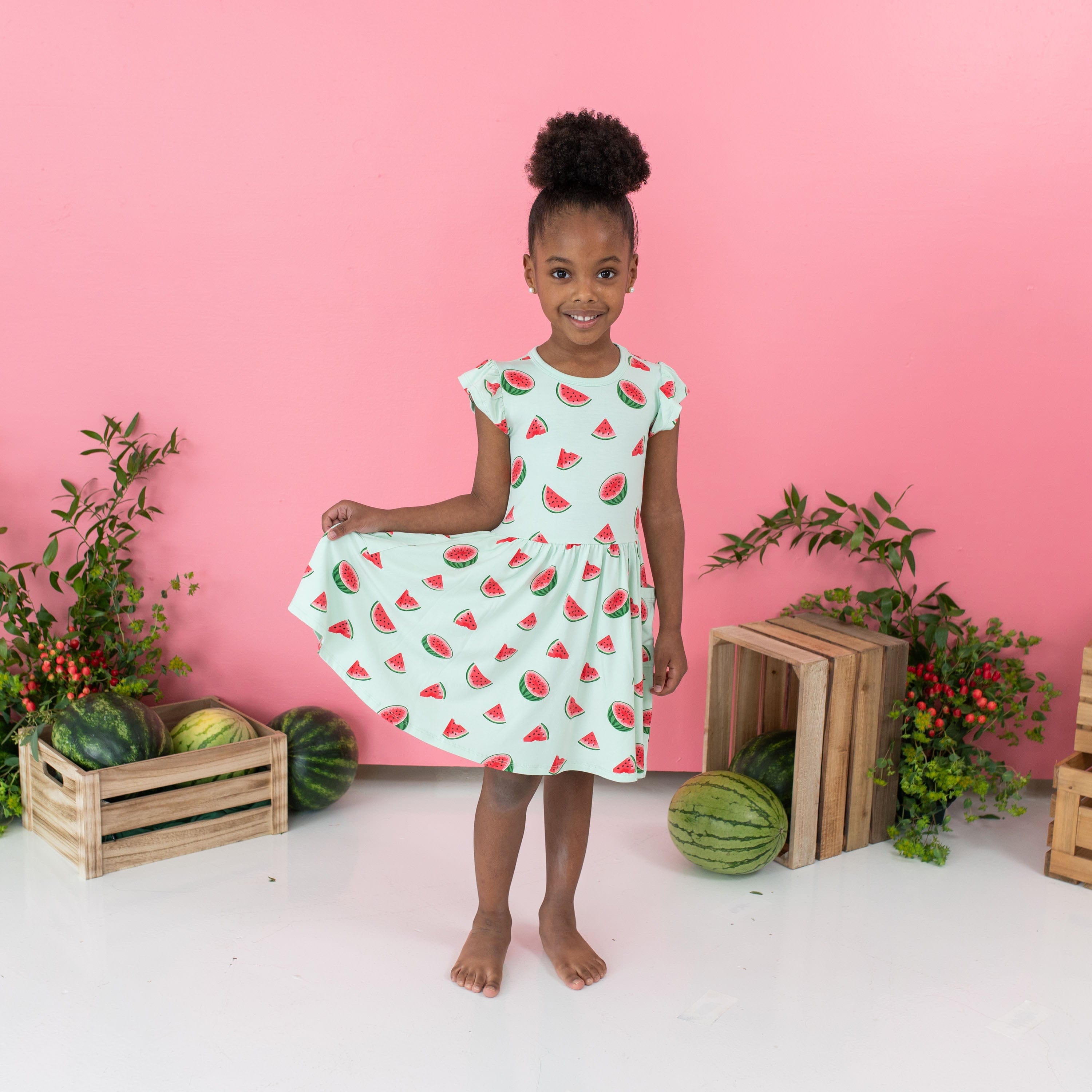 Girl wearing Kyte Baby Pocket Dress in Watermelon