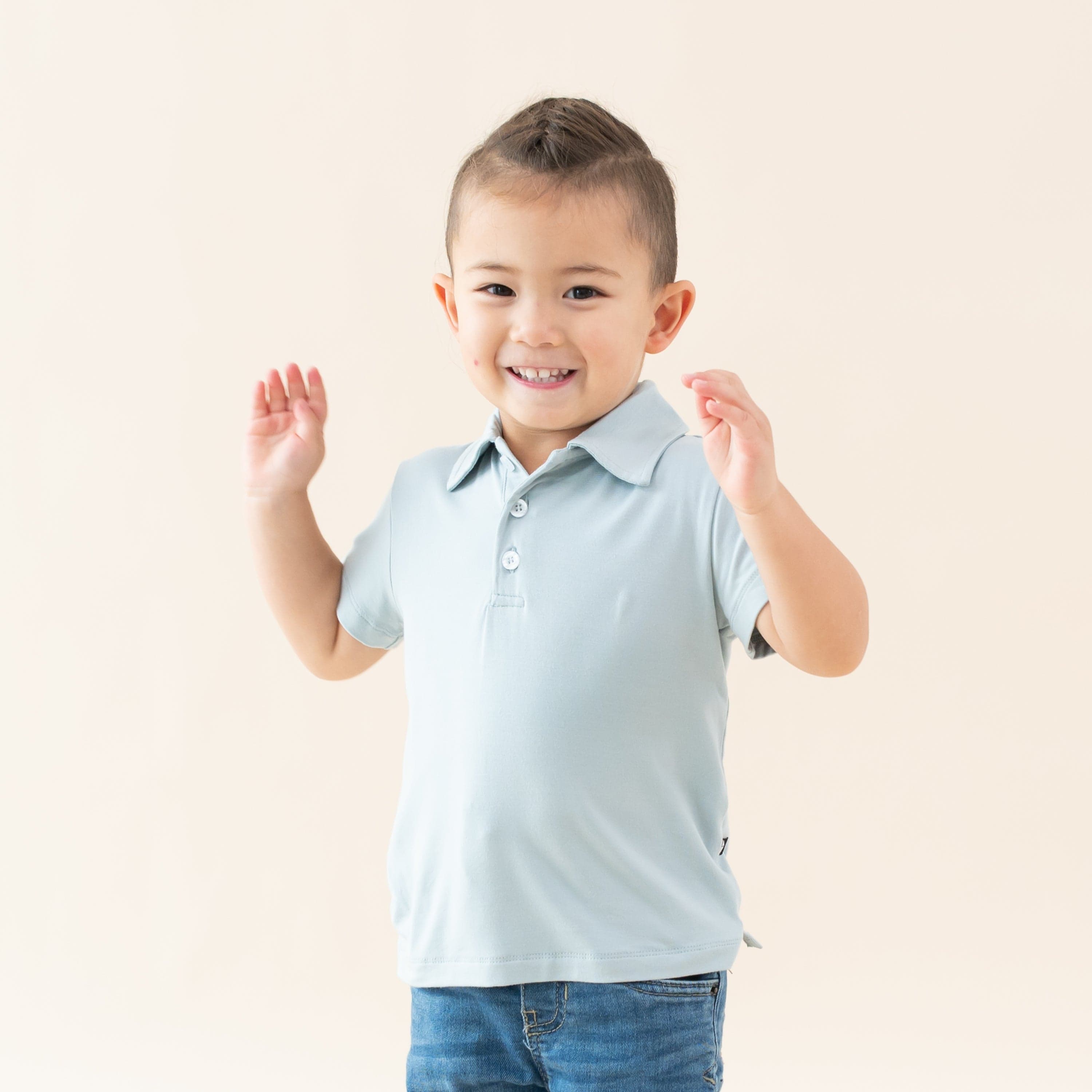 Toddler wearing Kyte Baby Short Sleeve Shirt with Polo Collar in Fog blue