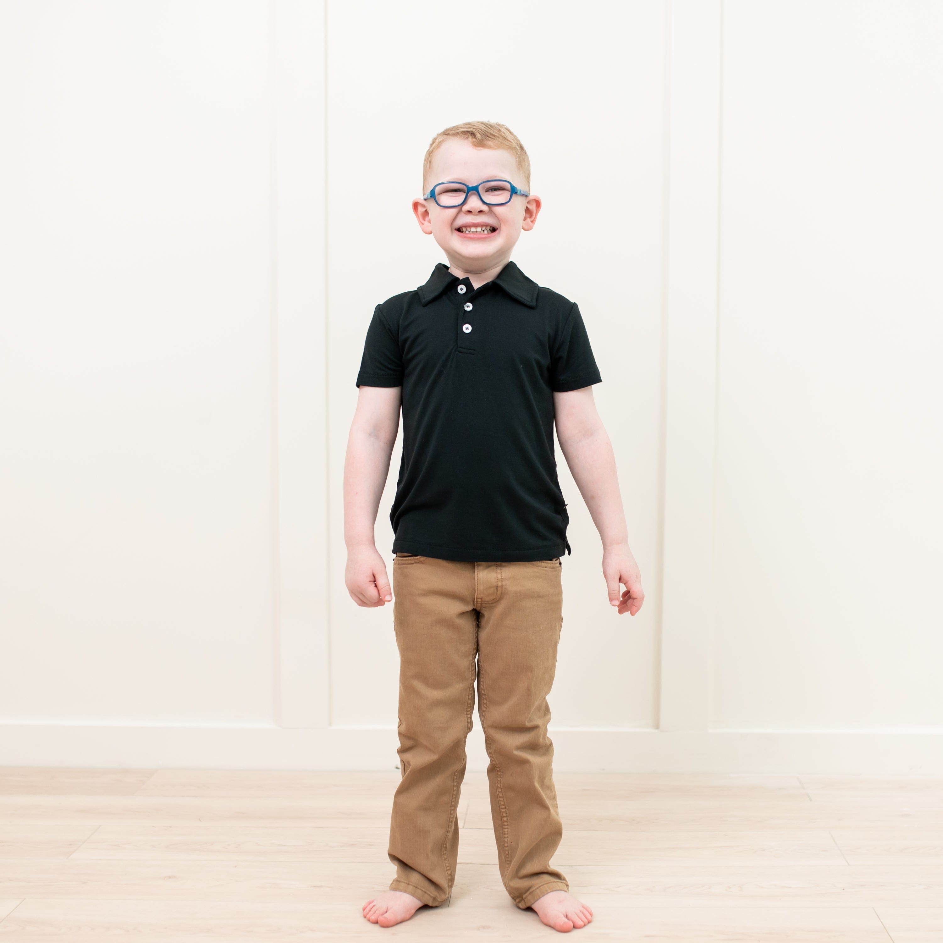 Toddler wearing Kyte Baby Short Sleeve Polo in Midnight
