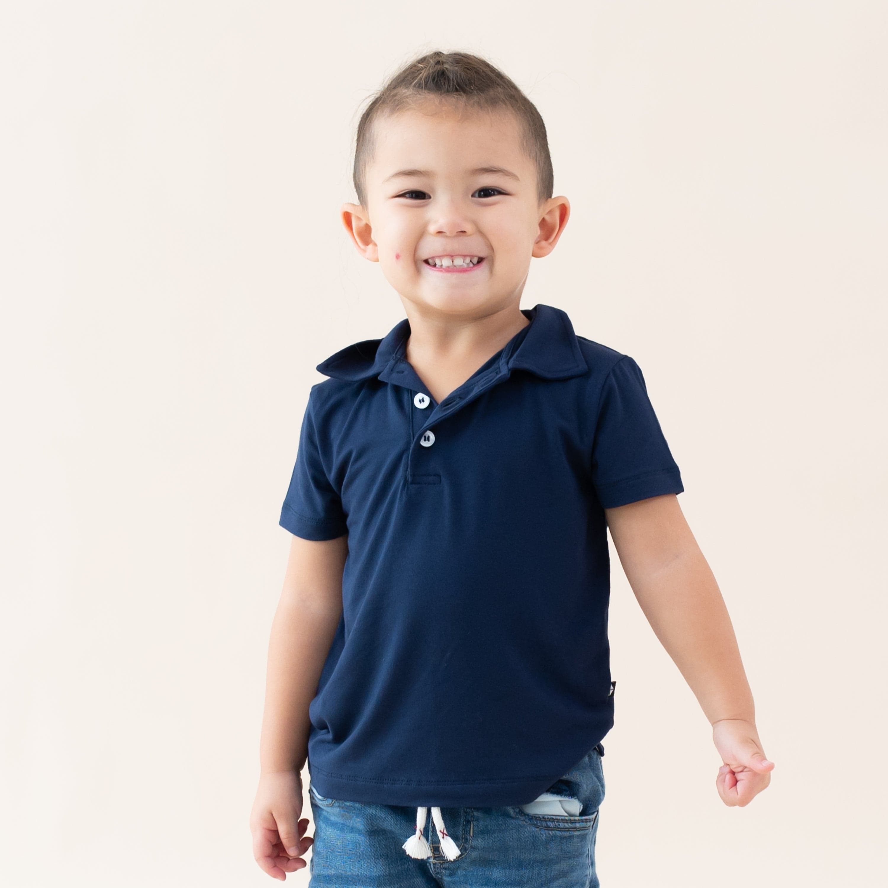 Toddler wearing Kyte Baby Short Sleeve Shirt with Polo Collar in Navy blue