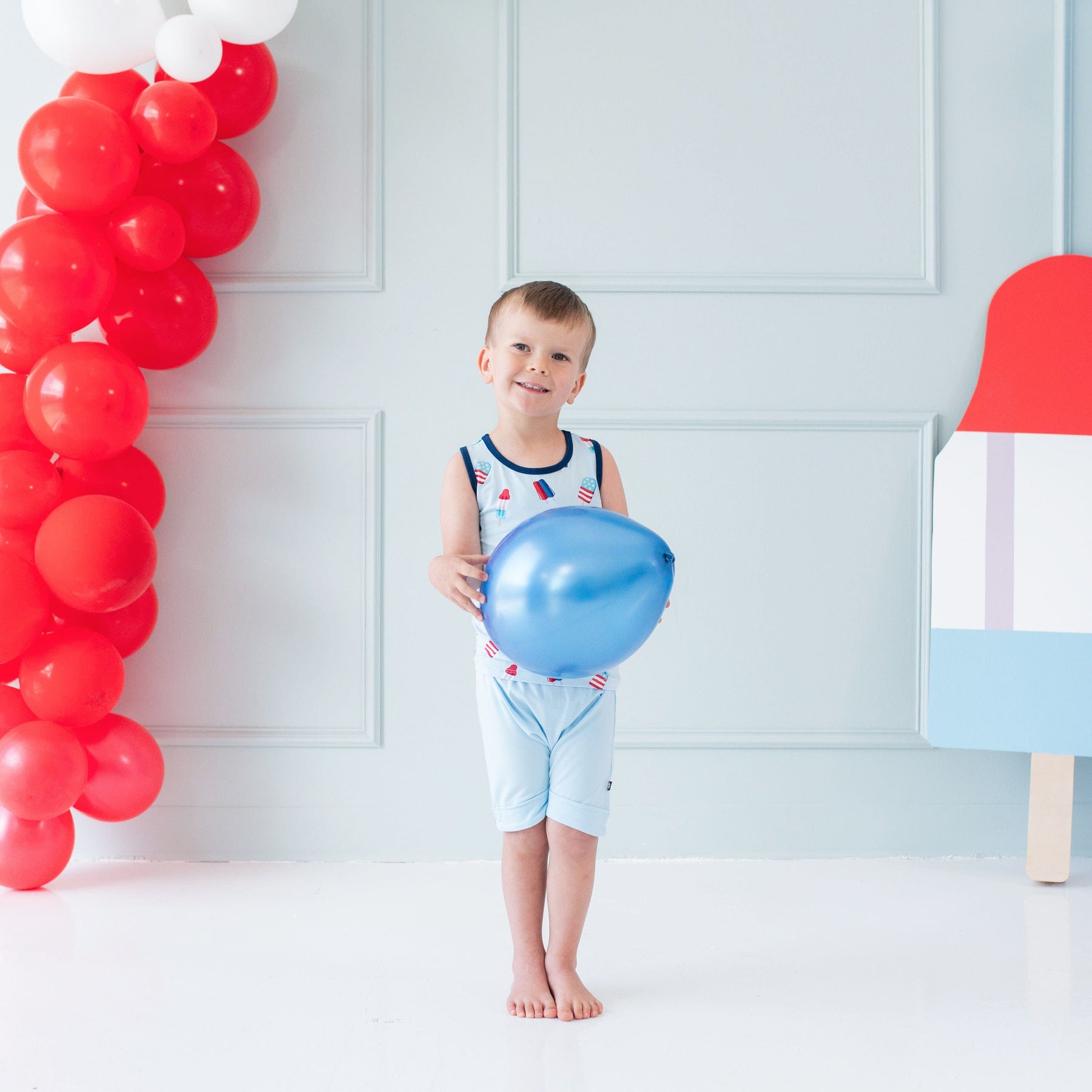 Toddler wearing Kyte Baby bamboo Tank Top in Popsicle