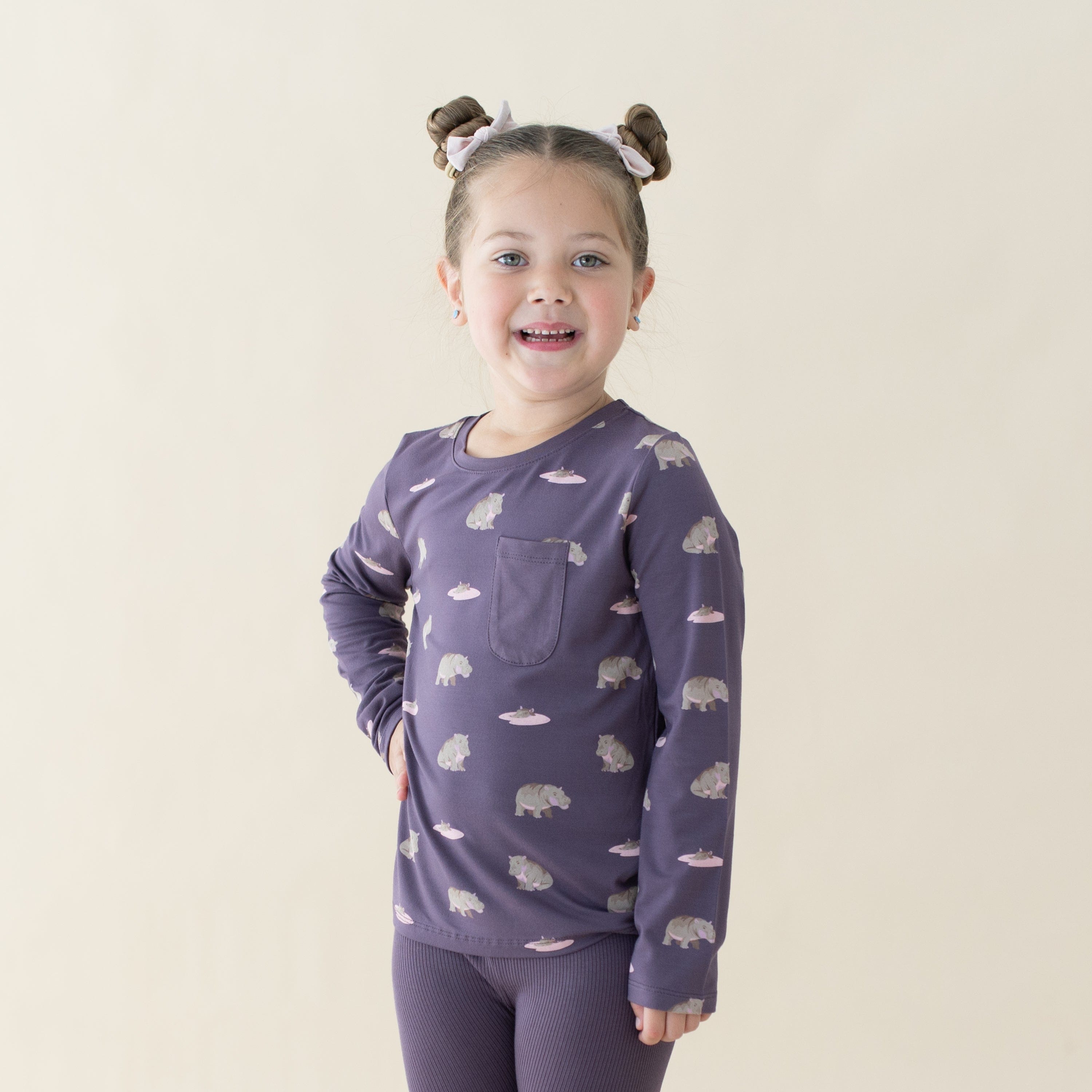 Girl wearing Kyte Baby bamboo Long Sleeve Toddler Crew Neck Tee in Baby Hippo