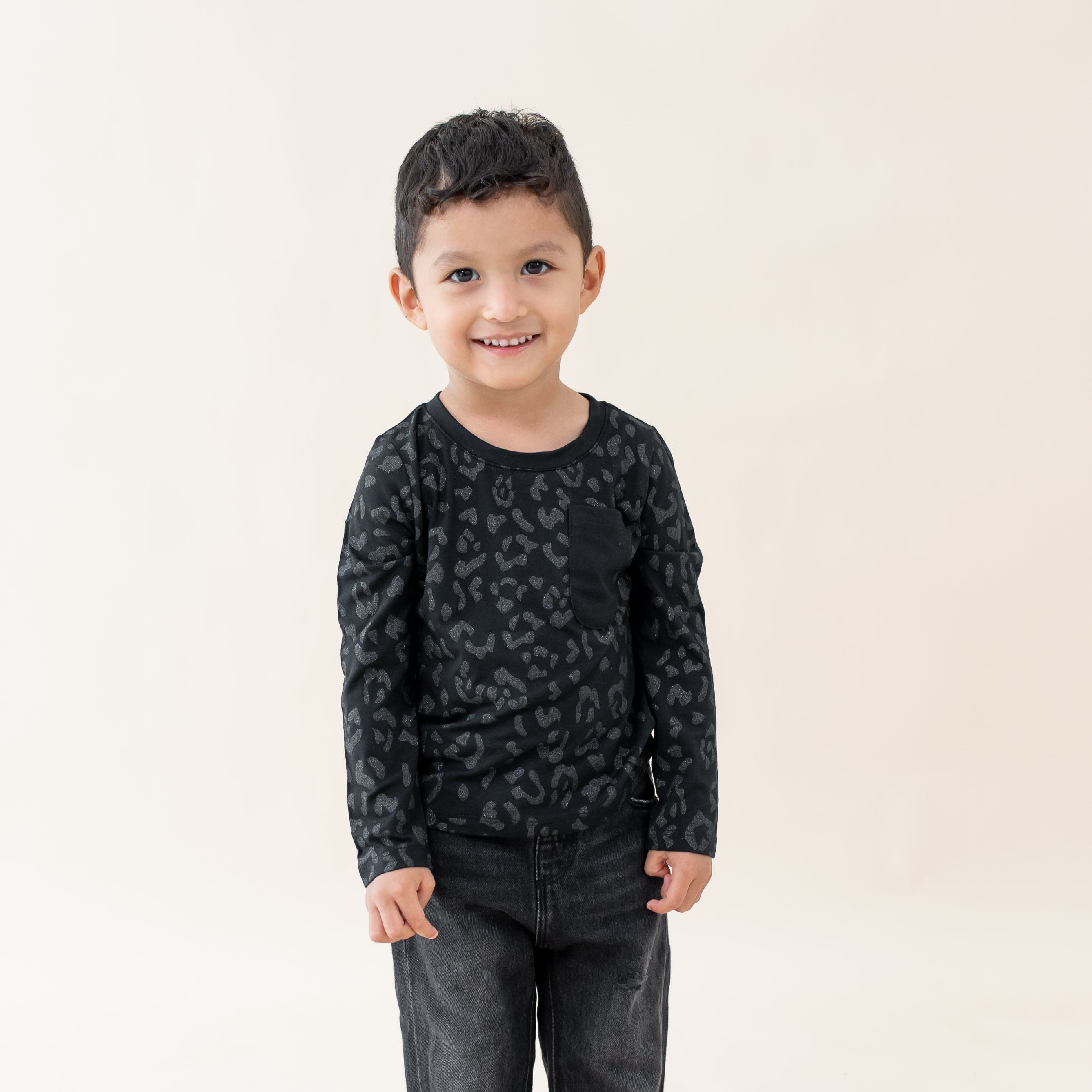 Child wearing Kyte Baby bamboo Long Sleeve Toddler Crew Neck Tee in Midnight Leopard