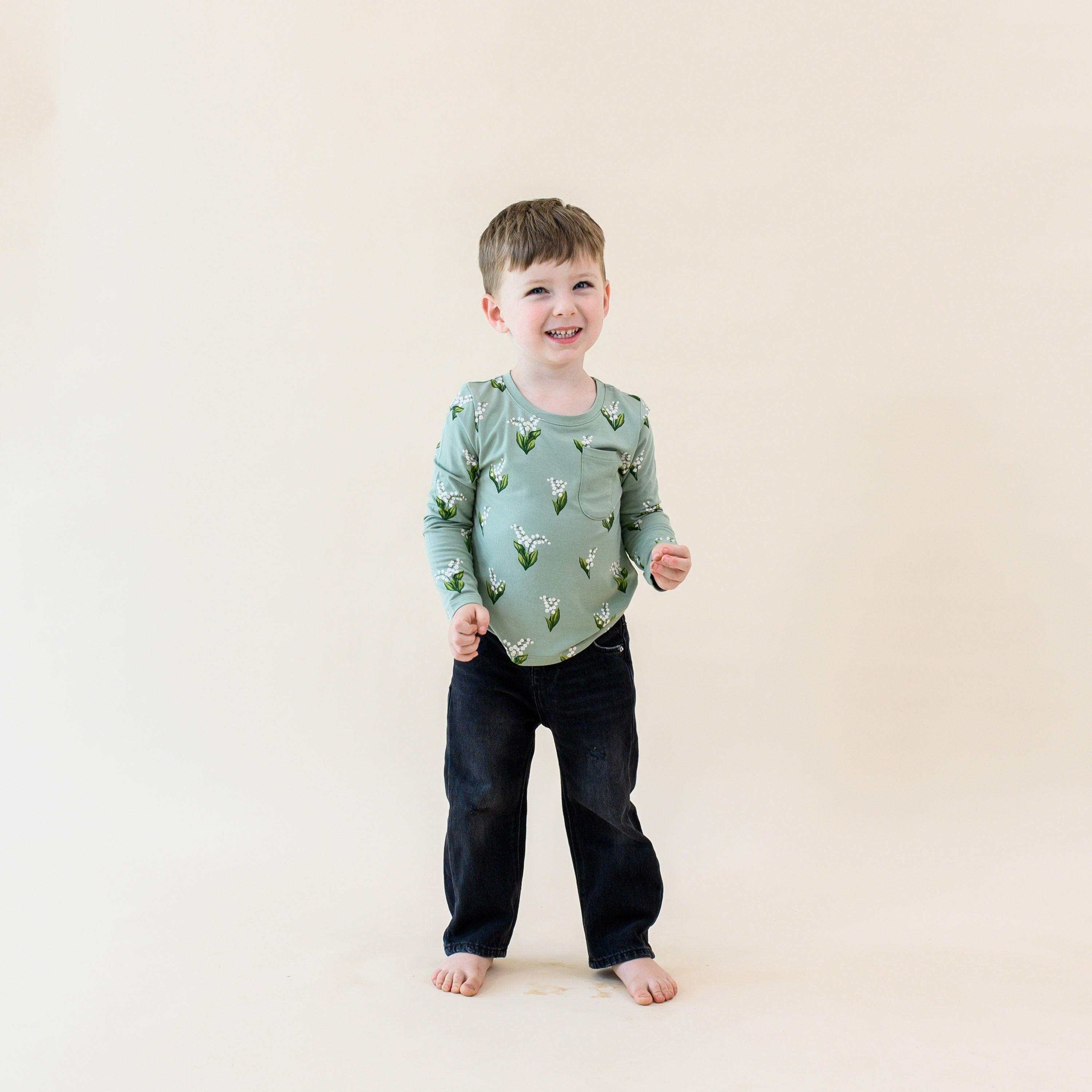 Child wearing Kyte Baby bamboo Long Sleeve Toddler Crew Neck Tee in Thyme Lily