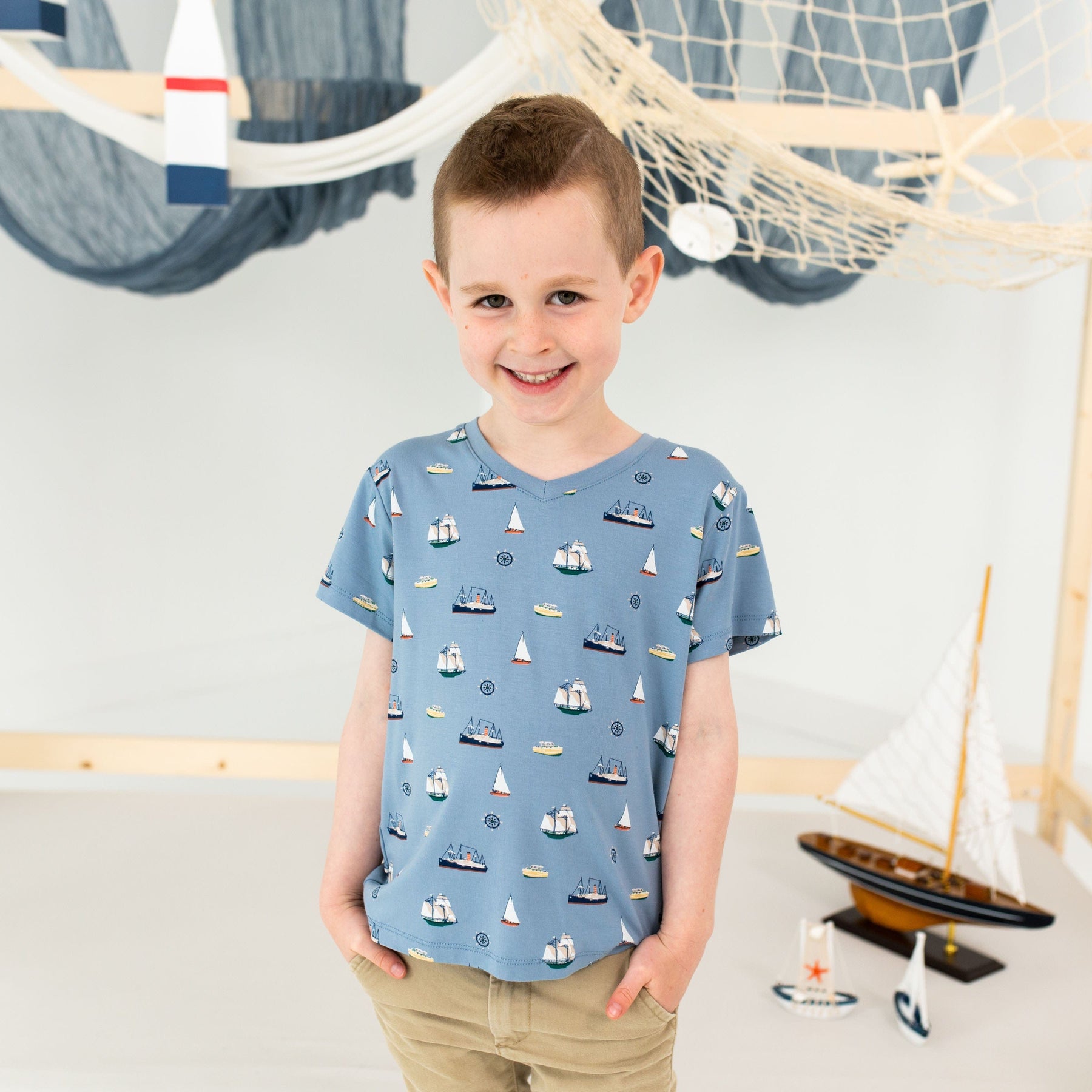 Boy wearing Kyte Baby Toddler V-Neck Tee in Vintage Boats