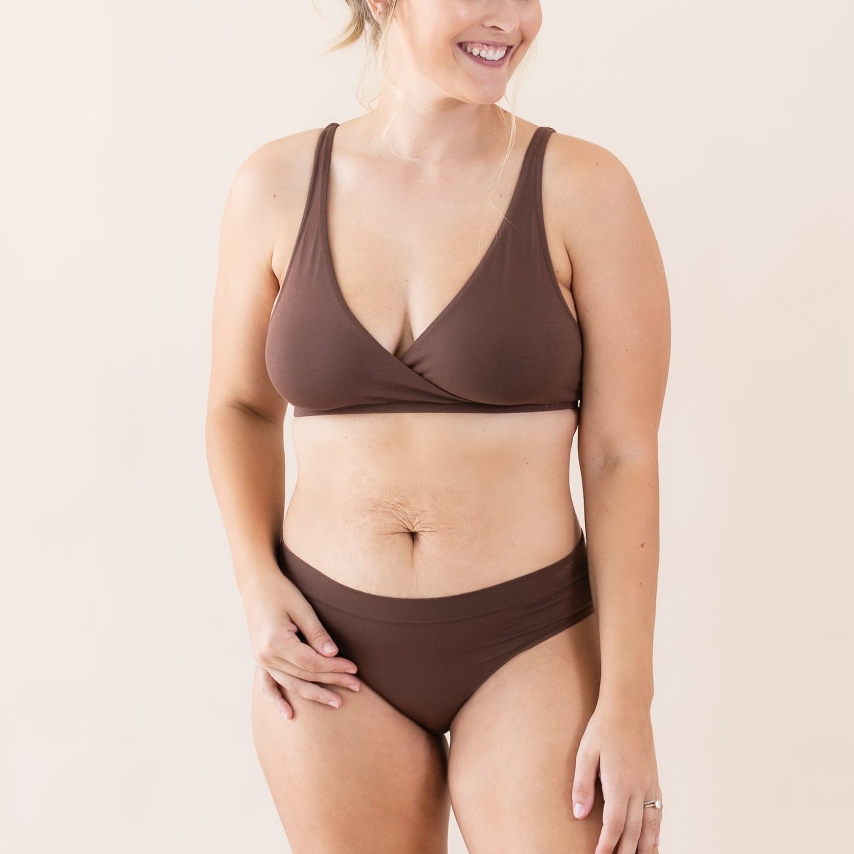 Woman wearing Kyte Baby Women's Cross Front Bralette in Toffee