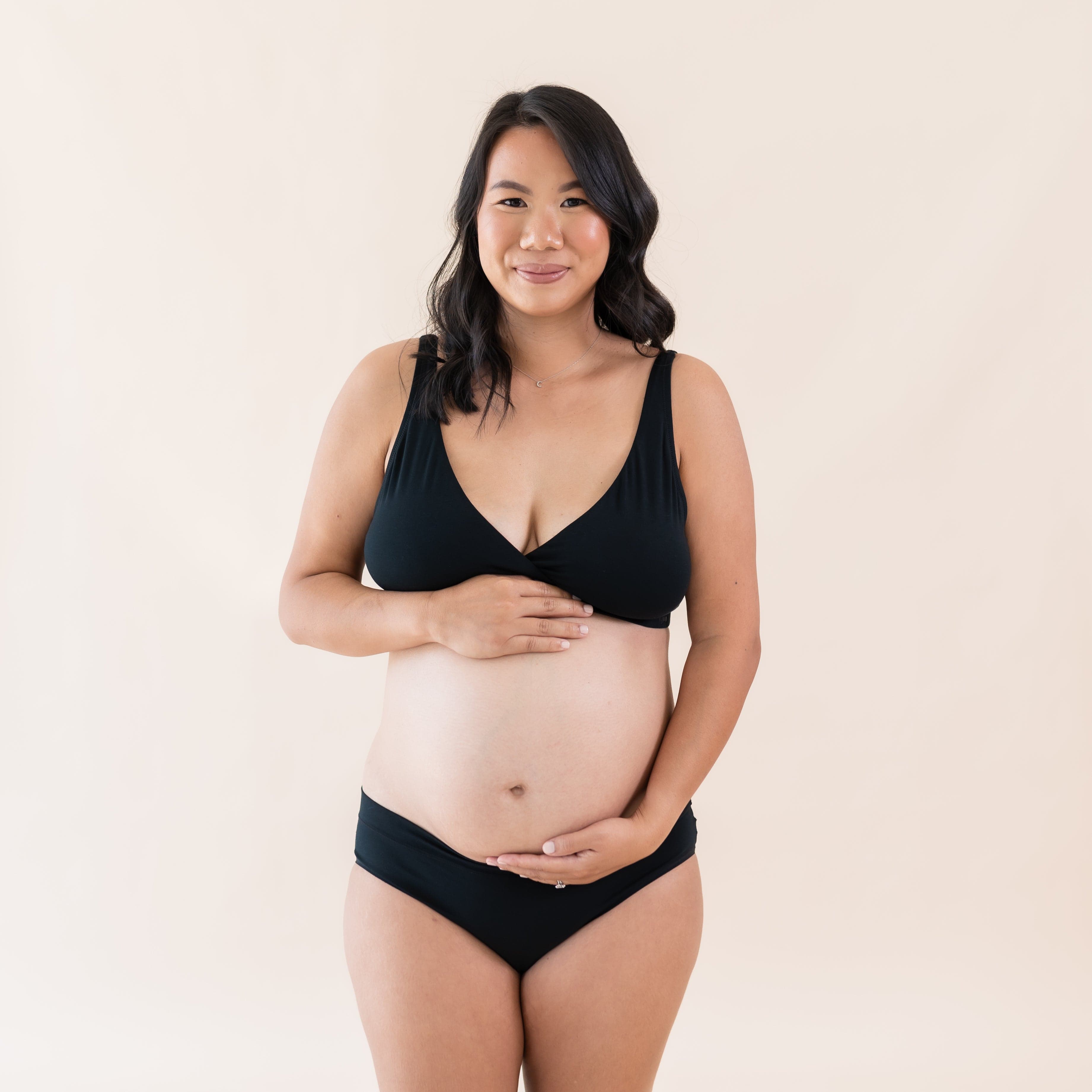 Woman wearing Kyte Baby Women's Cross Front Bralette in Midnight