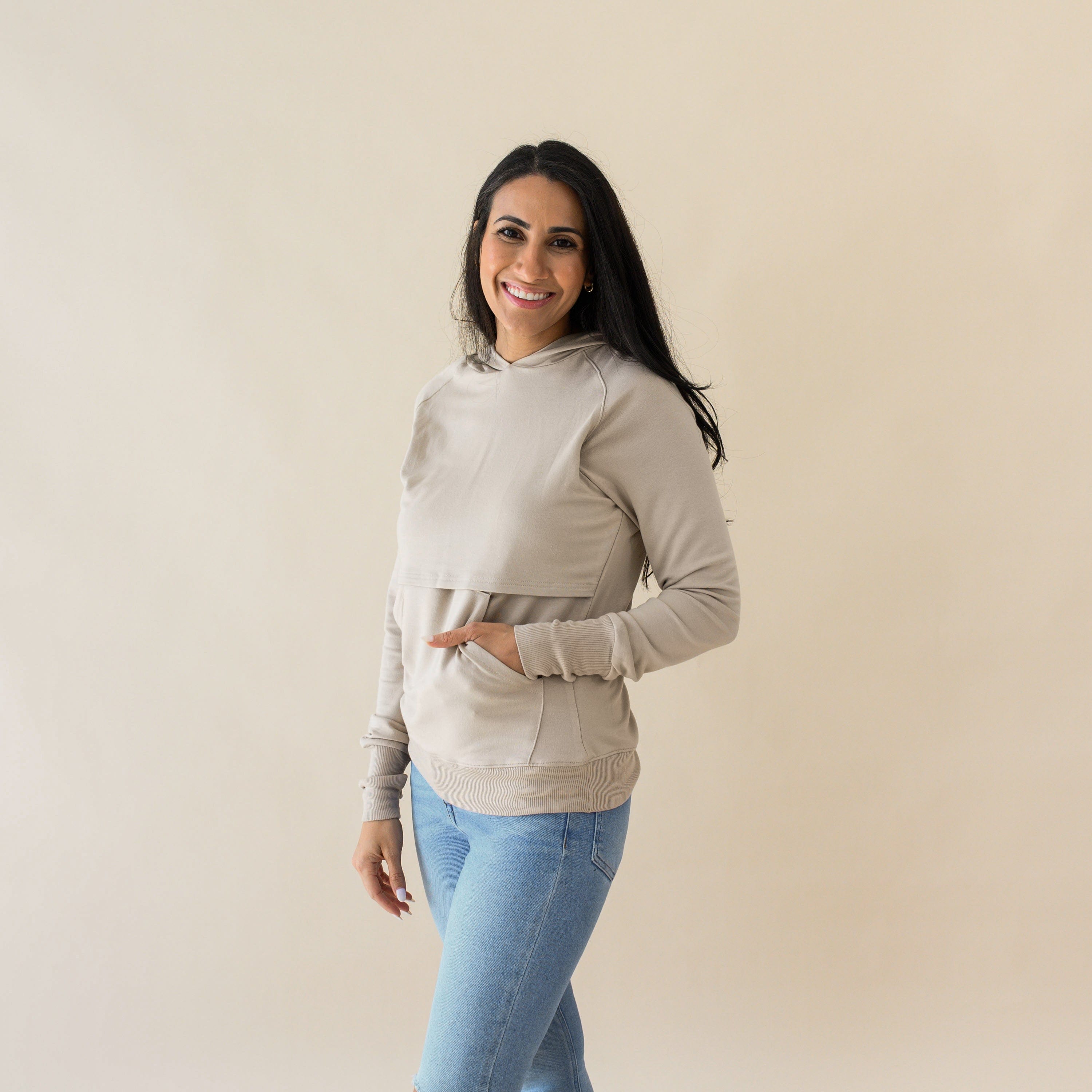 Woman wearing Kyte Baby Women's French Terry Nursing Hoodie in Almond