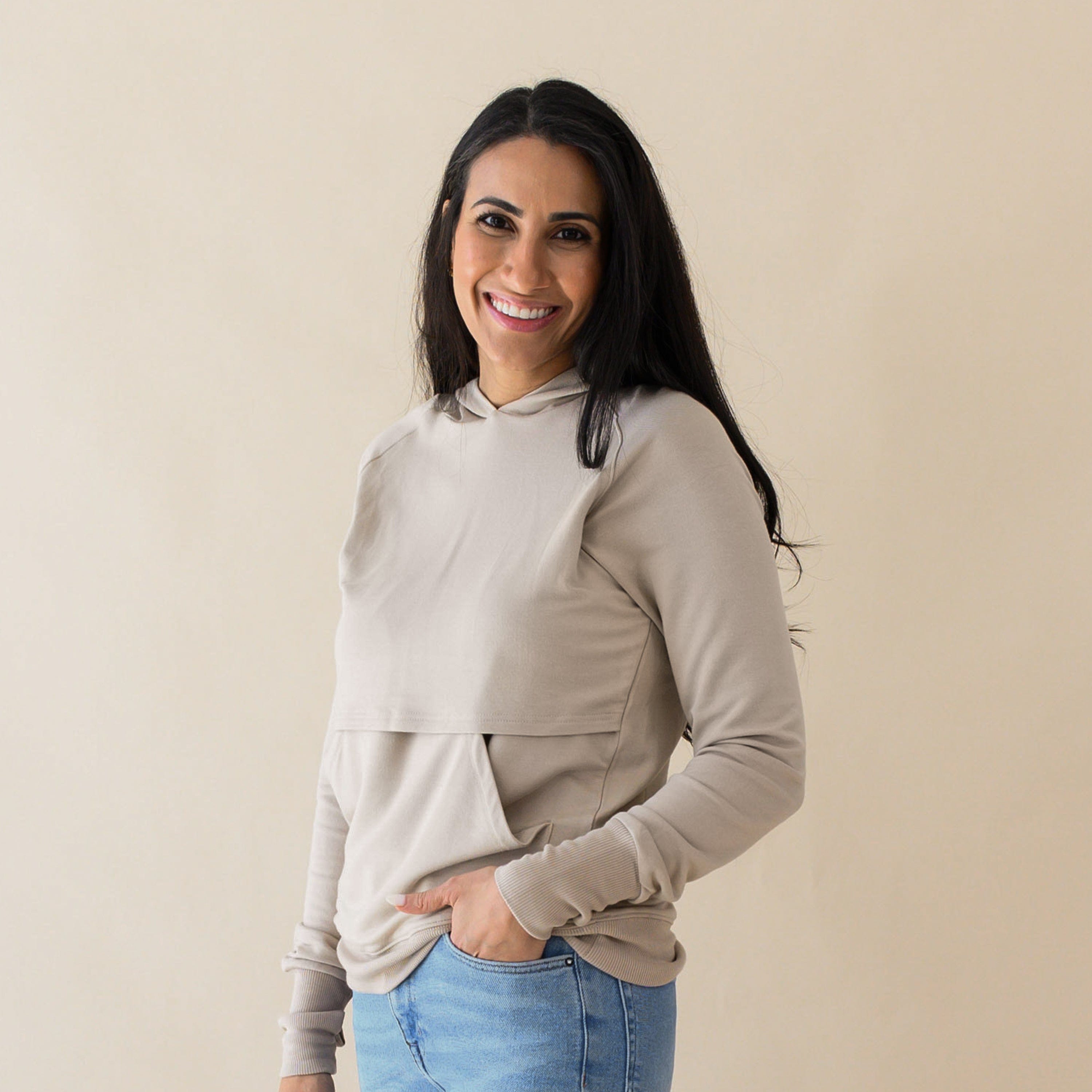 Woman wearing Kyte Baby Women's French Terry Bamboo Nursing Hoodie with Kangaroo Pocket in Almond