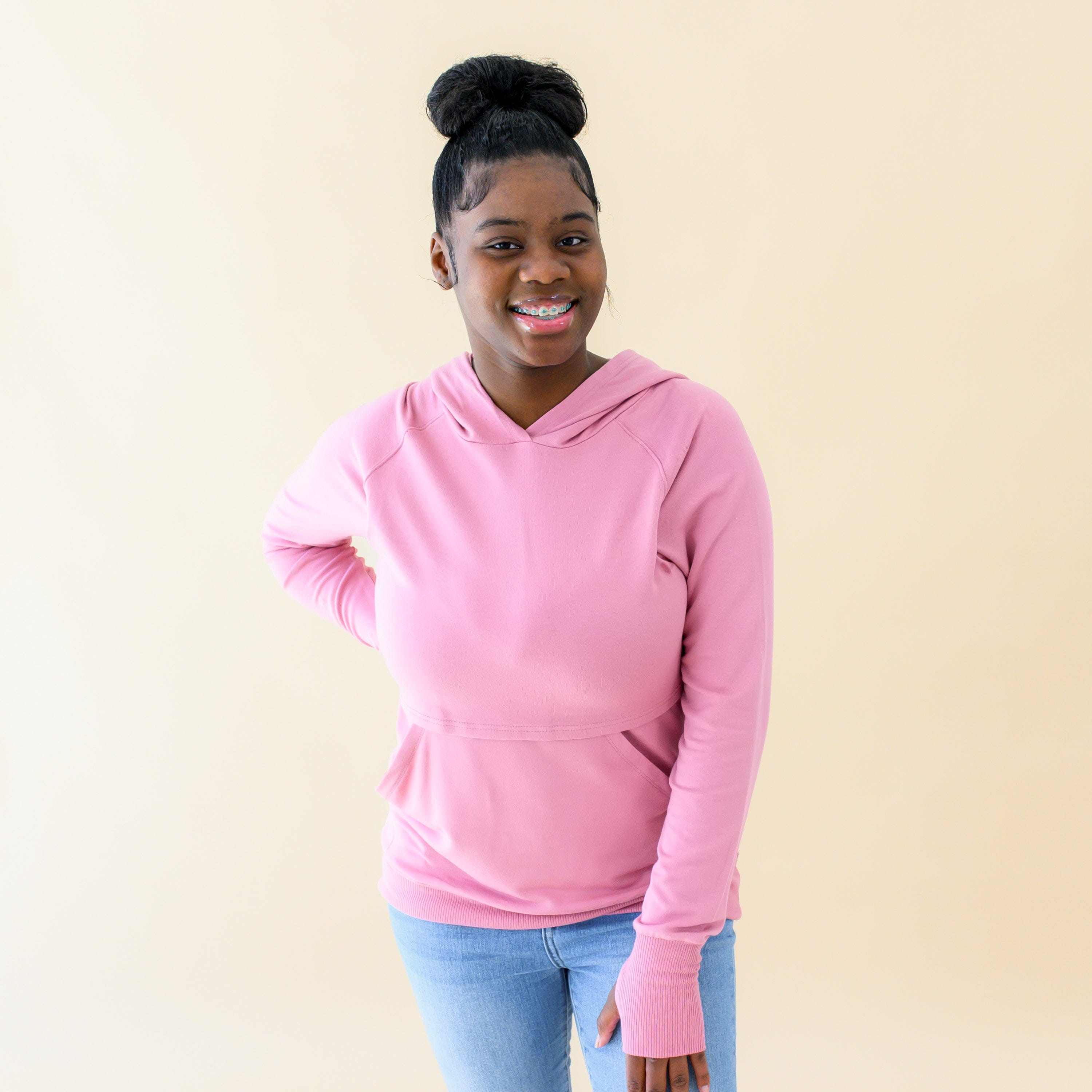 Woman wearing Kyte Baby Women's French Terry Nursing Hoodie in Apple Blossom
