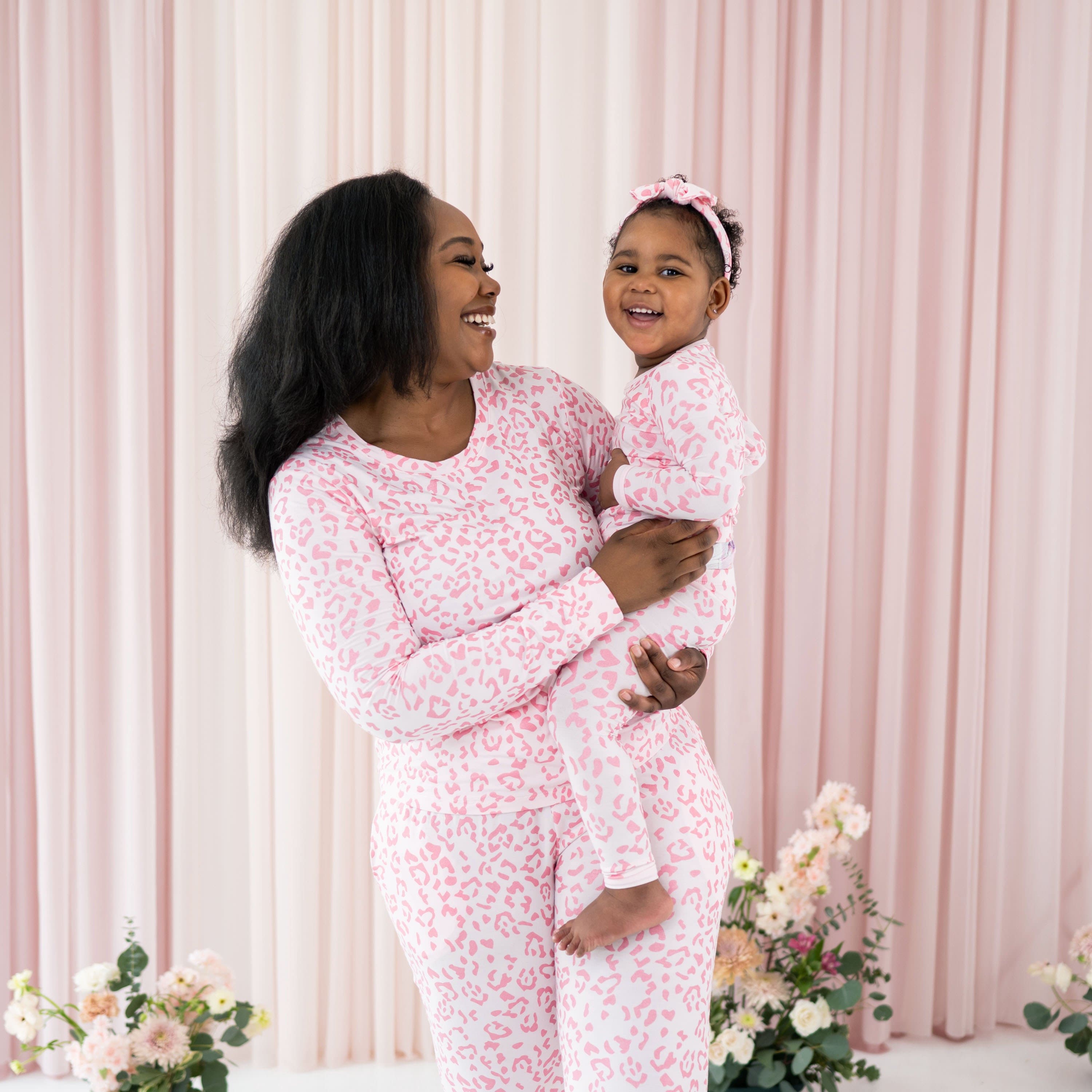 Mom and daughter wearing Kyte Baby matching Jogger Pajama Sets in Sakura Leopard