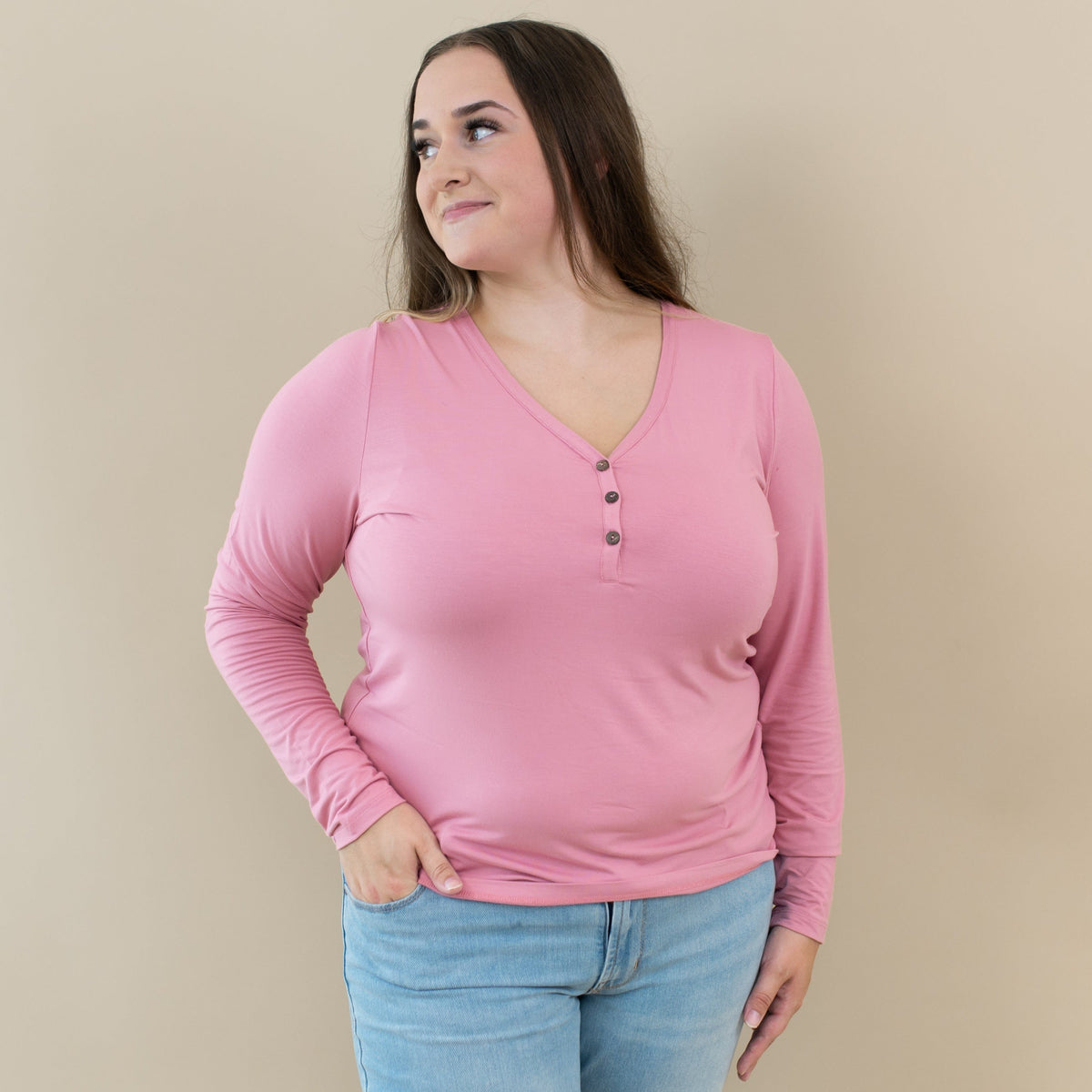 Woman wearing Kyte Baby Women's Bamboo Long Sleeve Henley Tee in Apple Blossom pink