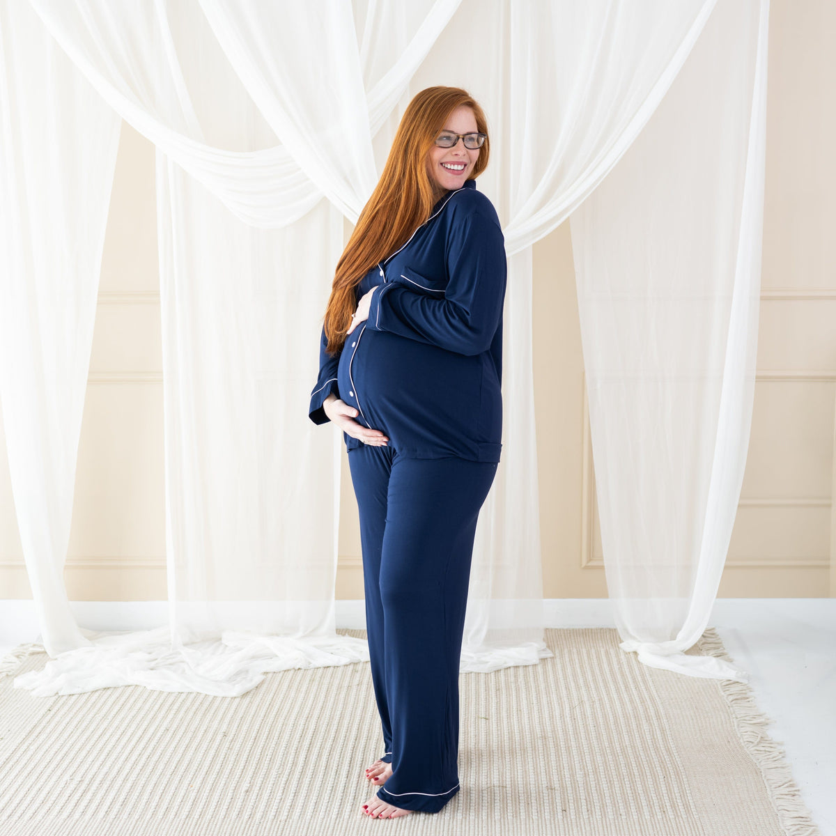 Woman wearing Women's Long Sleeve maternity Pajama Set in Navy with Cloud Trim