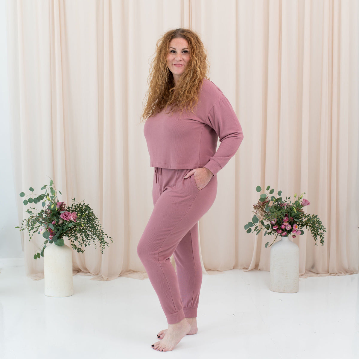 Woman wearing Kyte Baby Women's Ribbed bamboo Jogger Pant in Dusty Rose