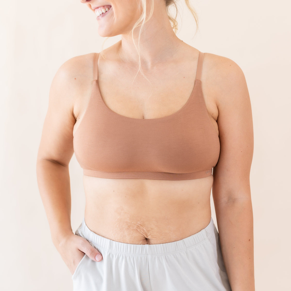 Woman wearing Kyte Baby Women's Scoop Neck Bralette in Latte