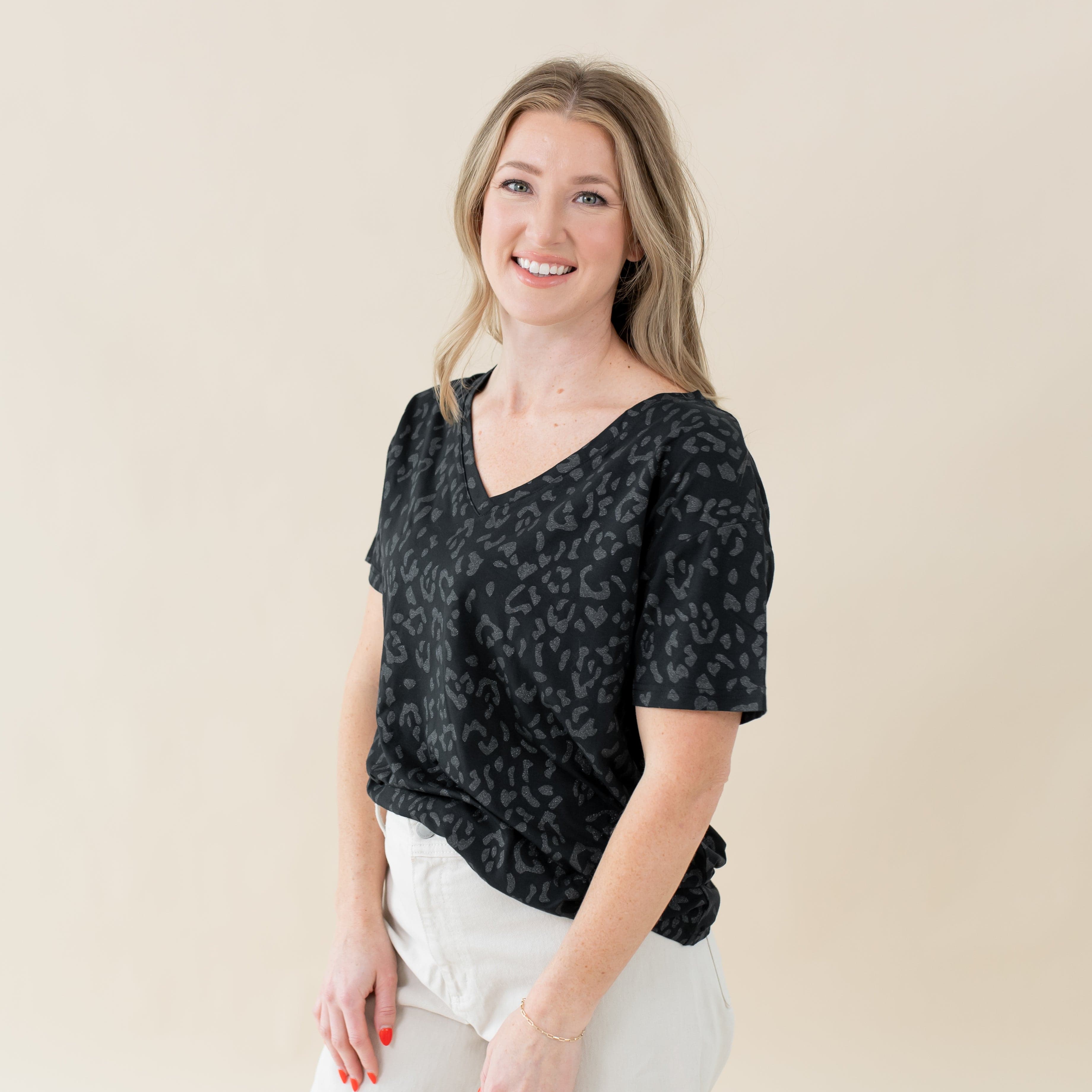 Woman wearing Kyte Baby Women's Relaxed Fit V-Neck in Midnight Leopard