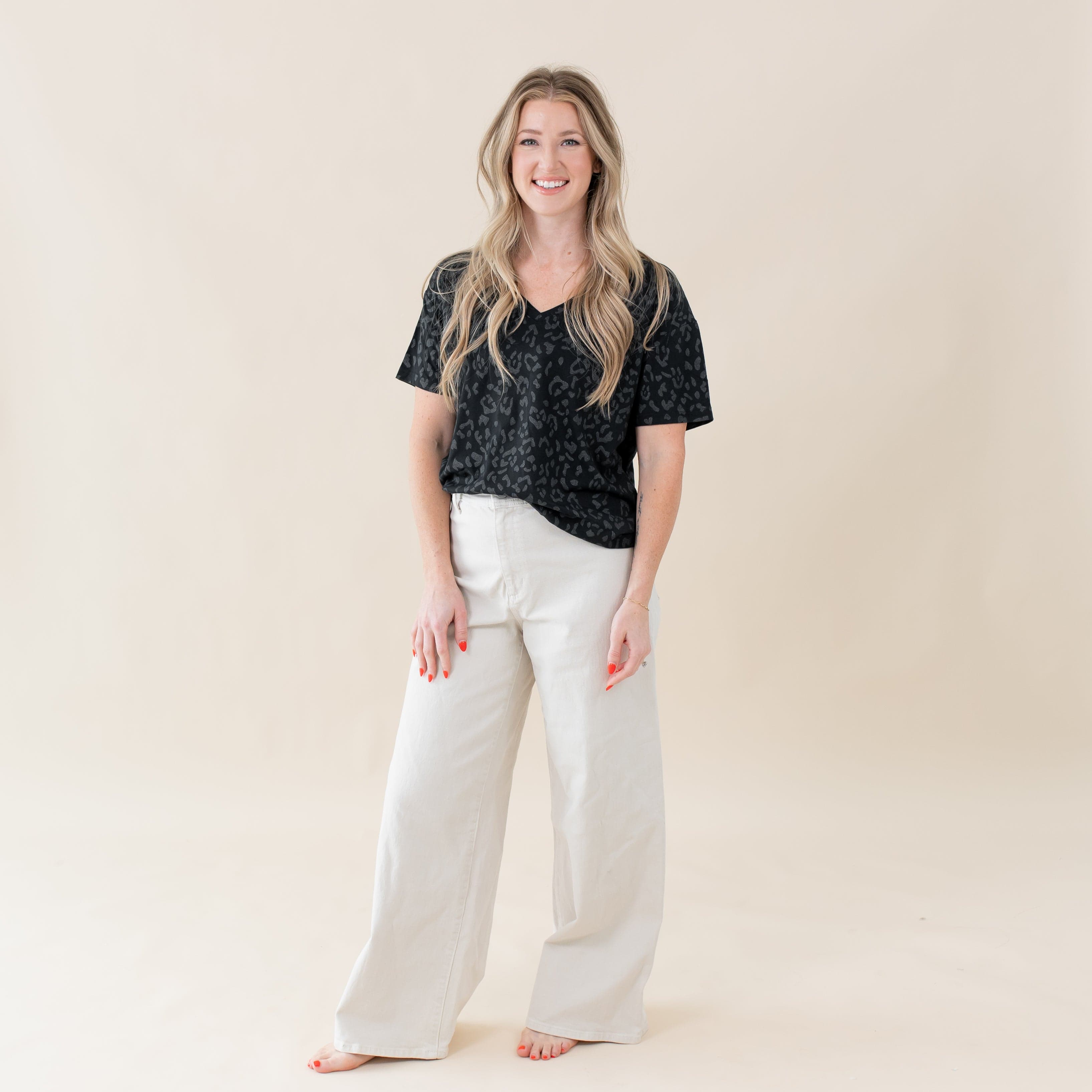 Woman wearing Kyte Baby Women's Relaxed Fit V-Neck tee in Midnight Leopard